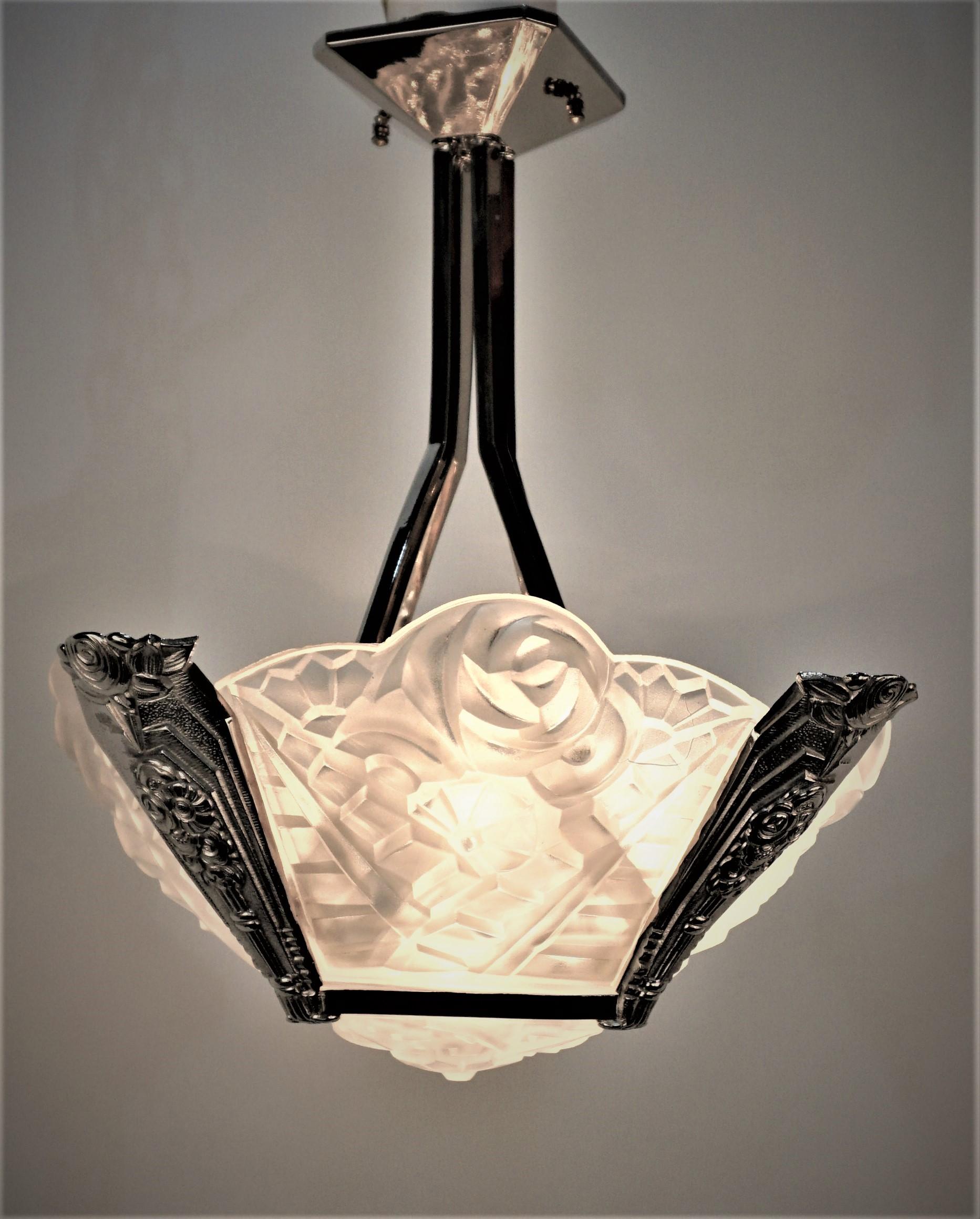 French Art Deco chandelier by Degue. Four clear frosted floral design surrounding a matching center panel with nickel on bronze deco design frame. 
Professionally rewired and ready for installation.