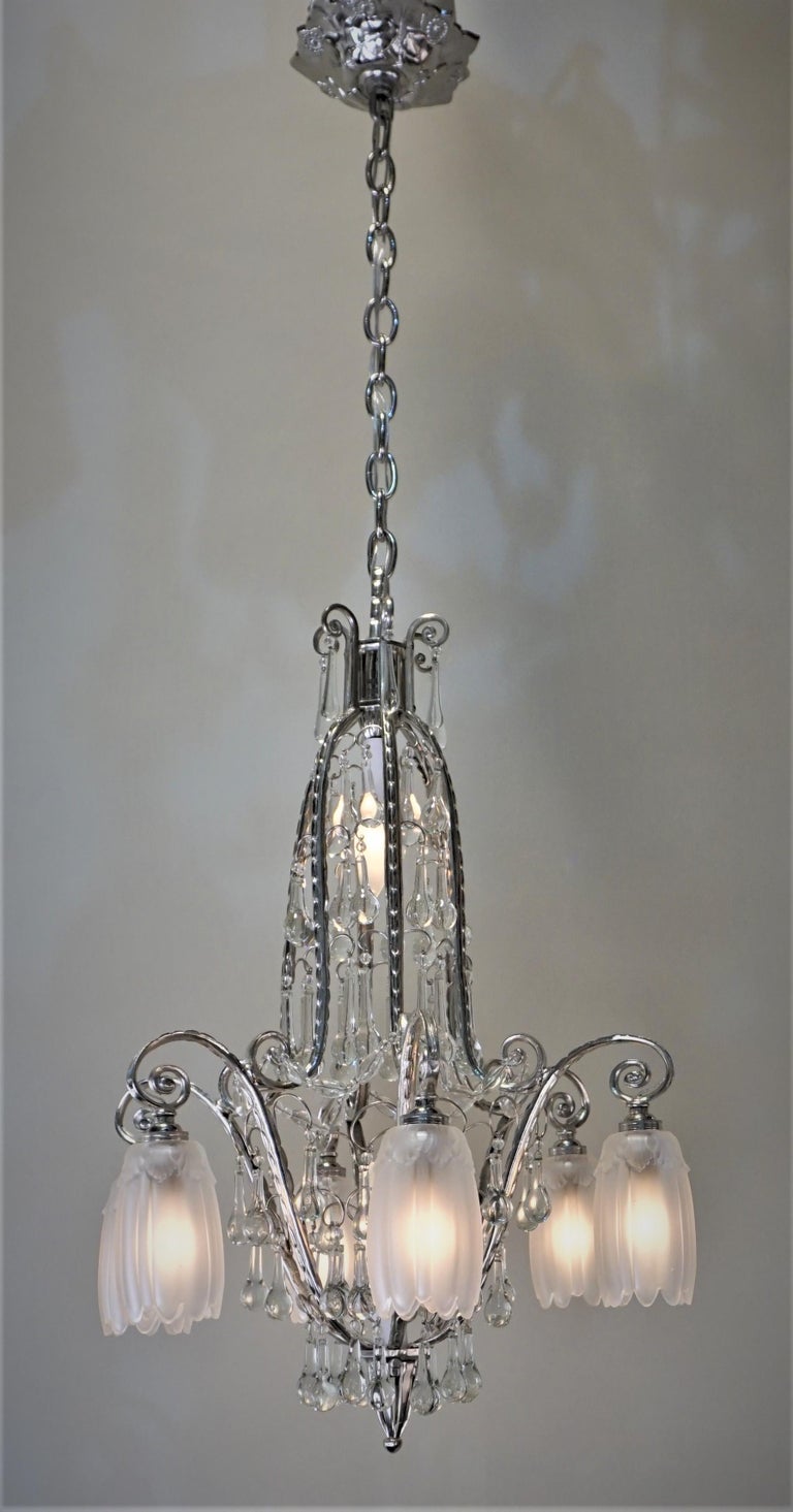 A fabulous rare art deco chandelier with crystal drops, clear frost glass shades and nickel on bronze body.
17