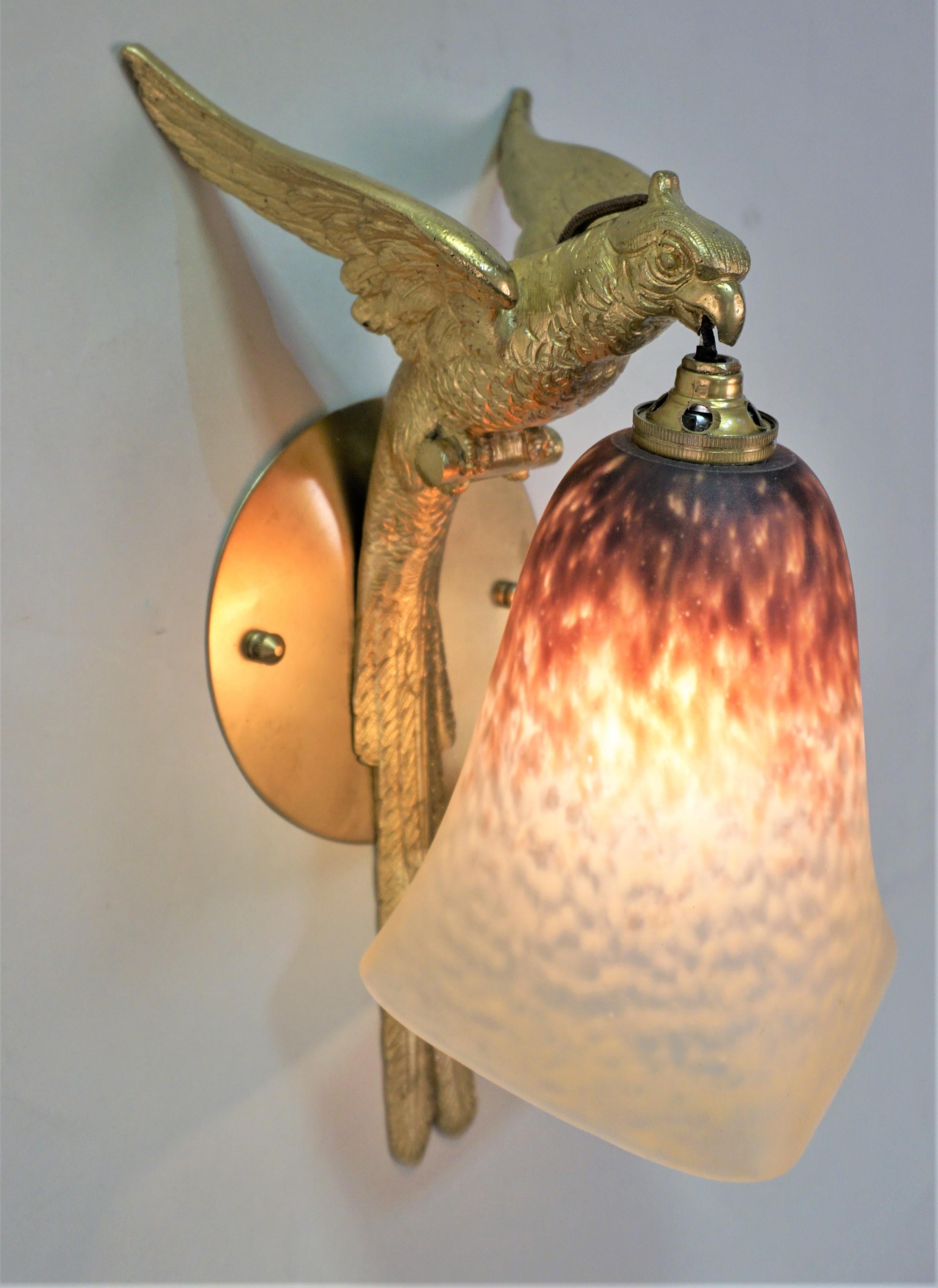 Bronze parrot with art glass shade wall sconce.