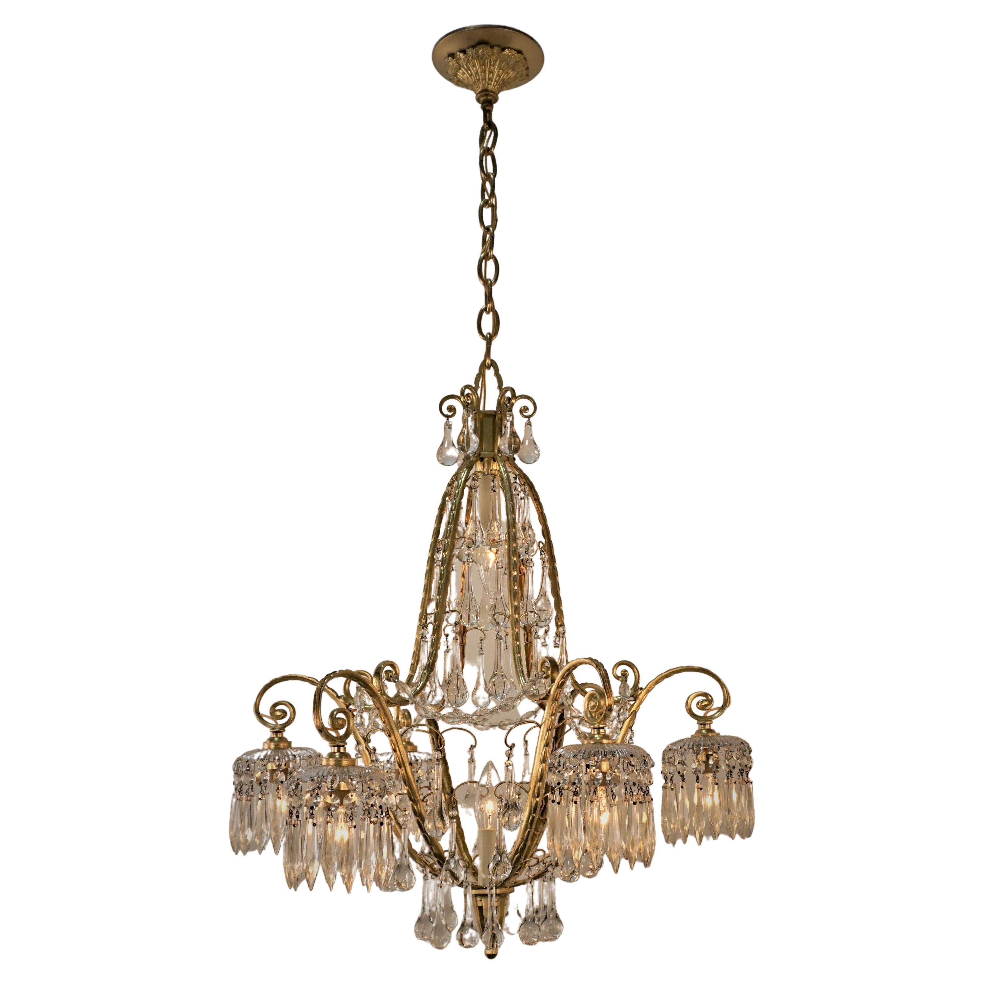 Elegant design from France dated 1930s has sparkling crystal and beautiful cast bronze chandelier.
Measurement: 22