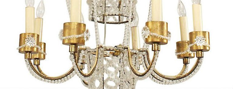 French (1930's) hot air balloon shaped chandelier with basket supporting 8 gilt metal arms with beaded crystal trim. (att: BAGUES; restored)
