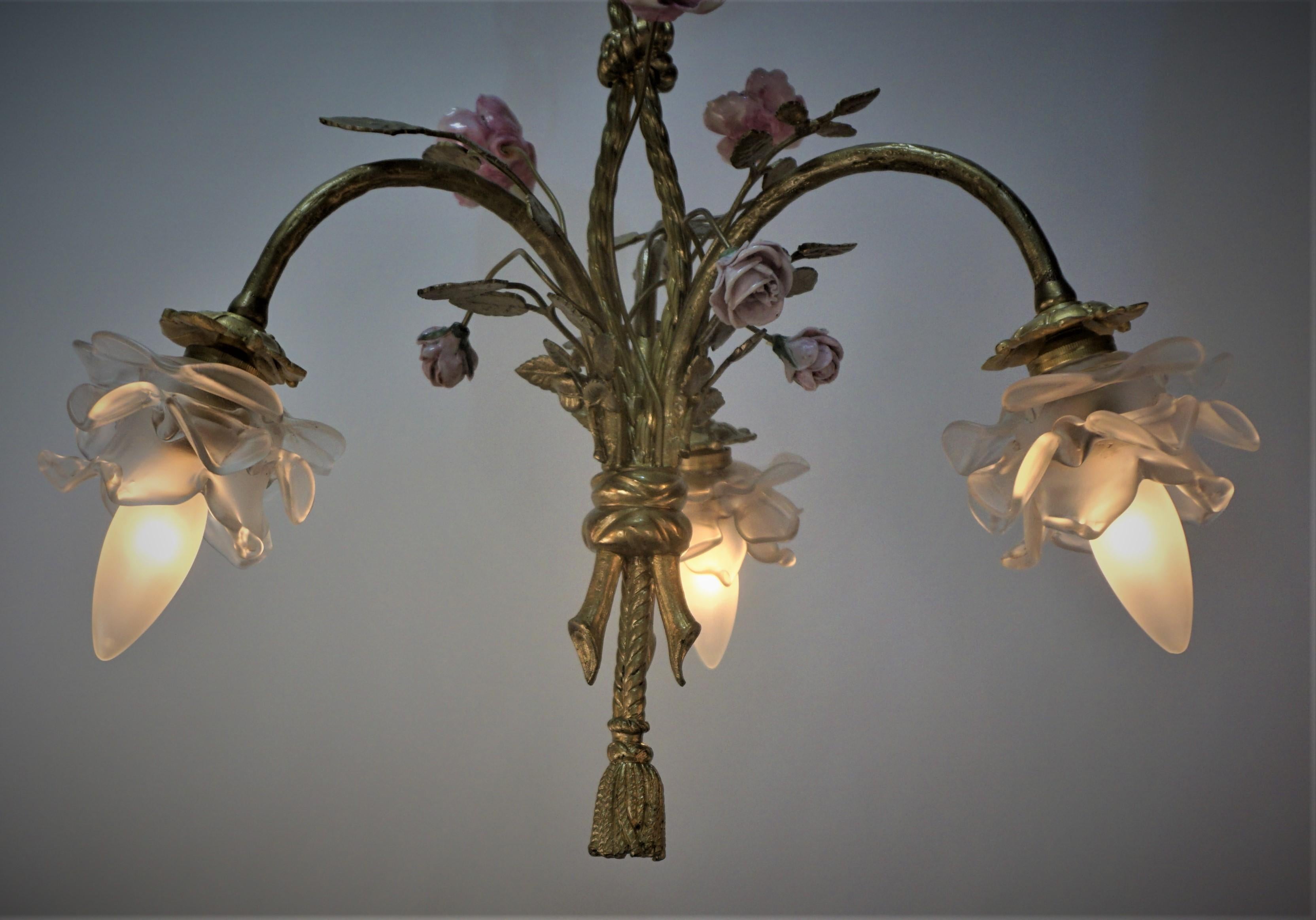 French bronze chandelier with beautiful glass rose shades and porcelain flowers.