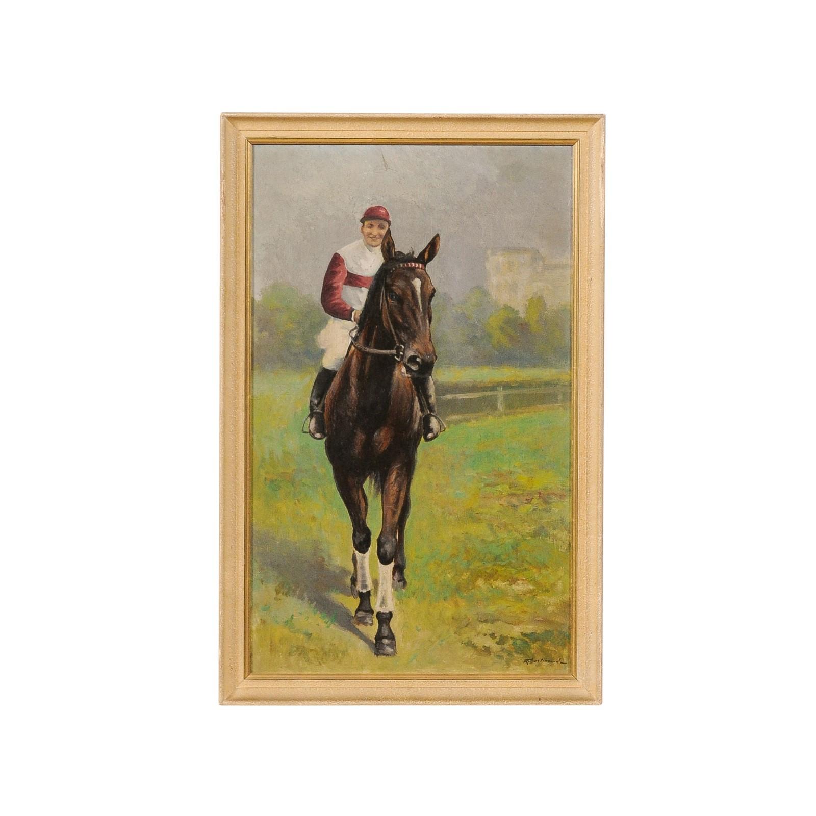 A French vertical framed painting from the early 20th century, depicting a horse and a jockey and signed lower right. Created in France during second quarter of the 20th century, this oil on old wooden fiberboard painting depicts a smiling jockey