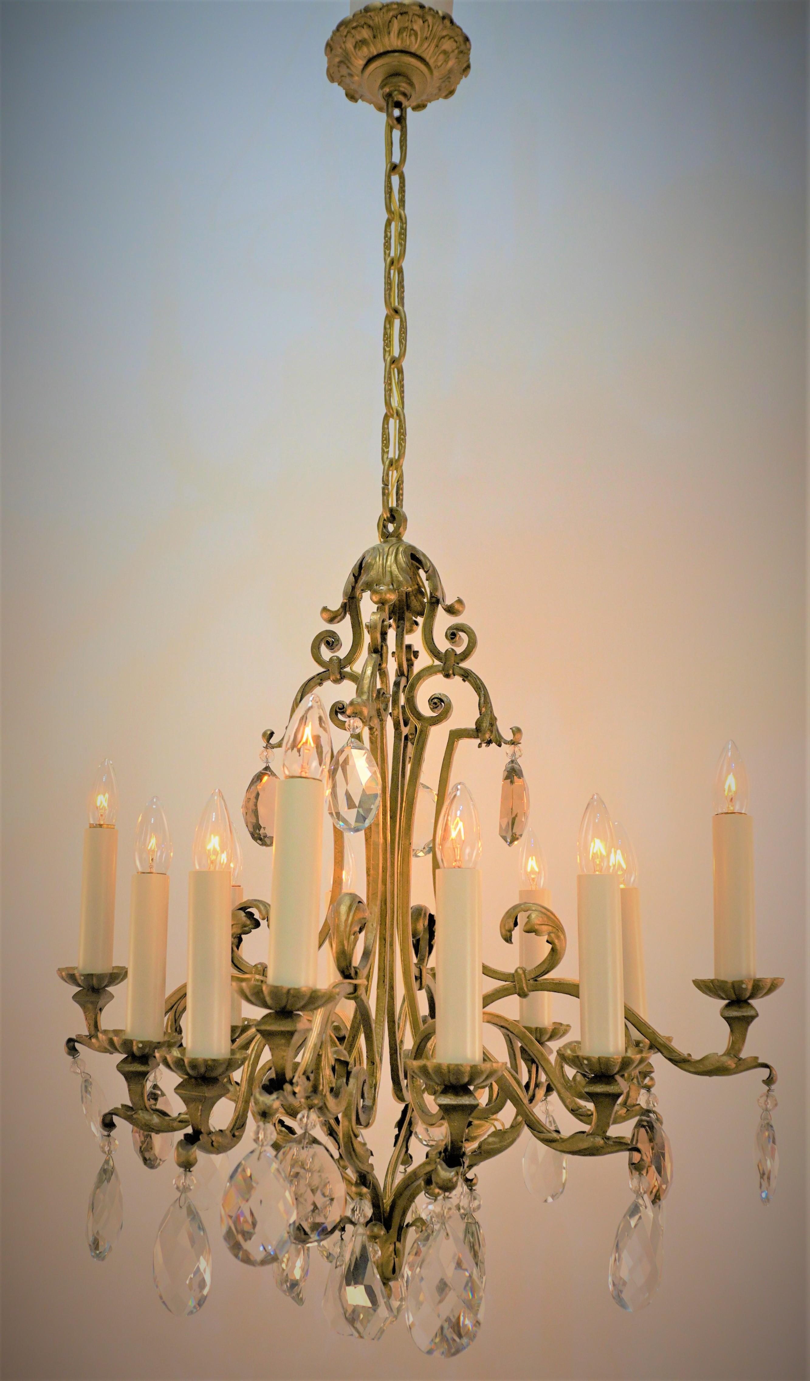 French 1930's beautiful twelve cut crystal and gilt iron chandelier.
Measurement: 27
