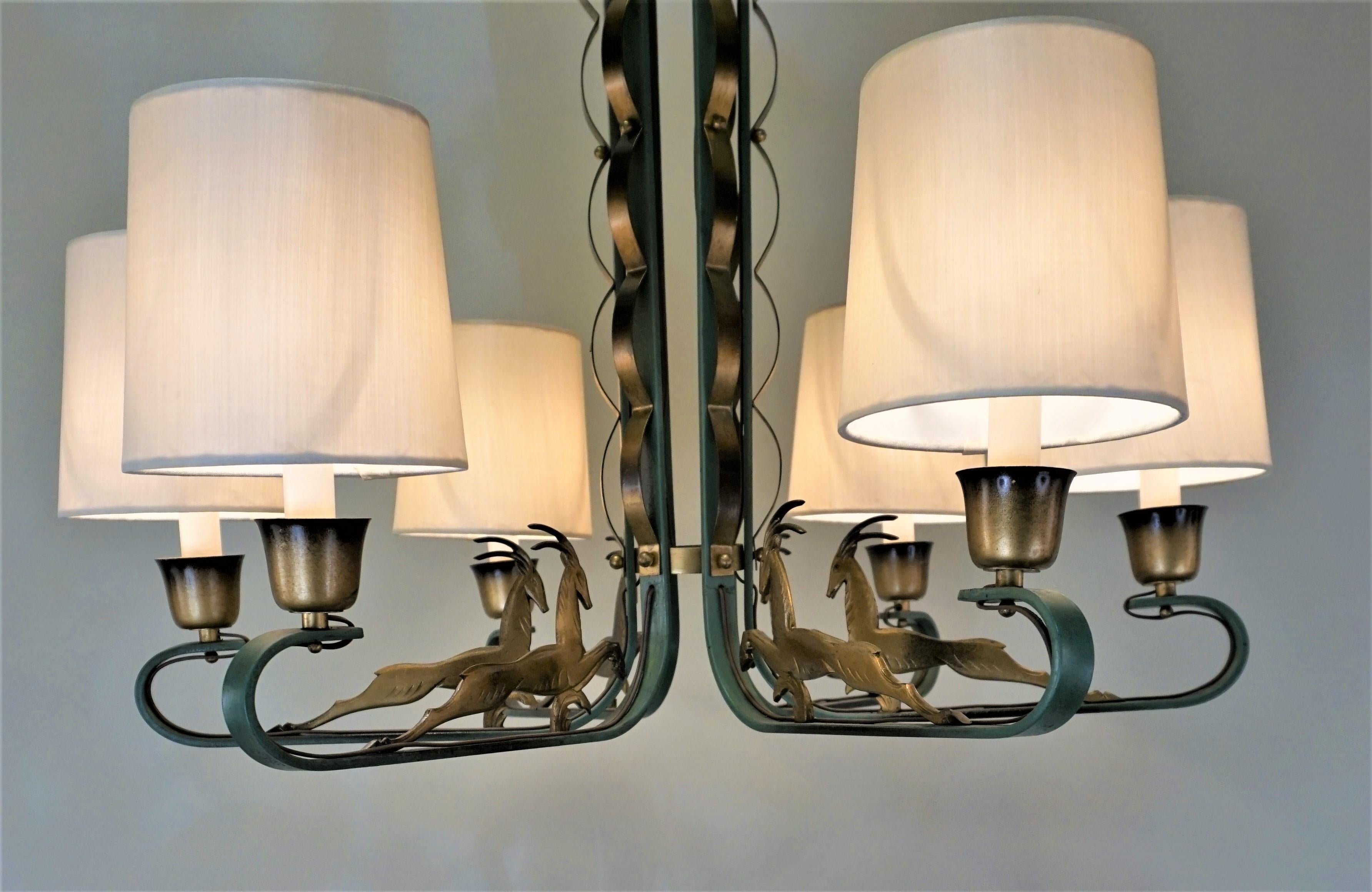 A rare 1930s Art Deco chandelier in Verdi green gold fitted with customized silk lampshades.