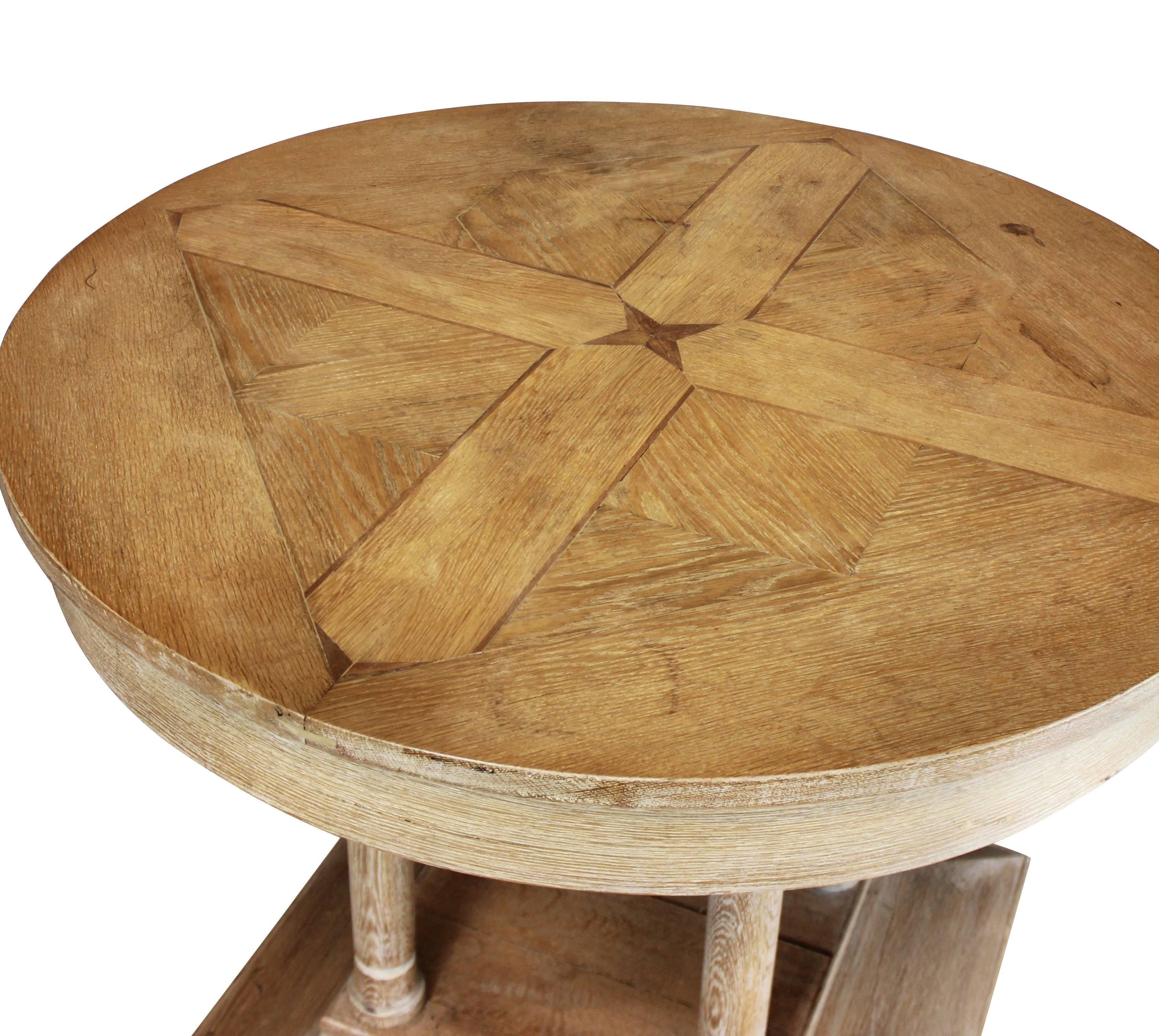 A fine French limed oak centre table with pillar base and a geometric top.
  