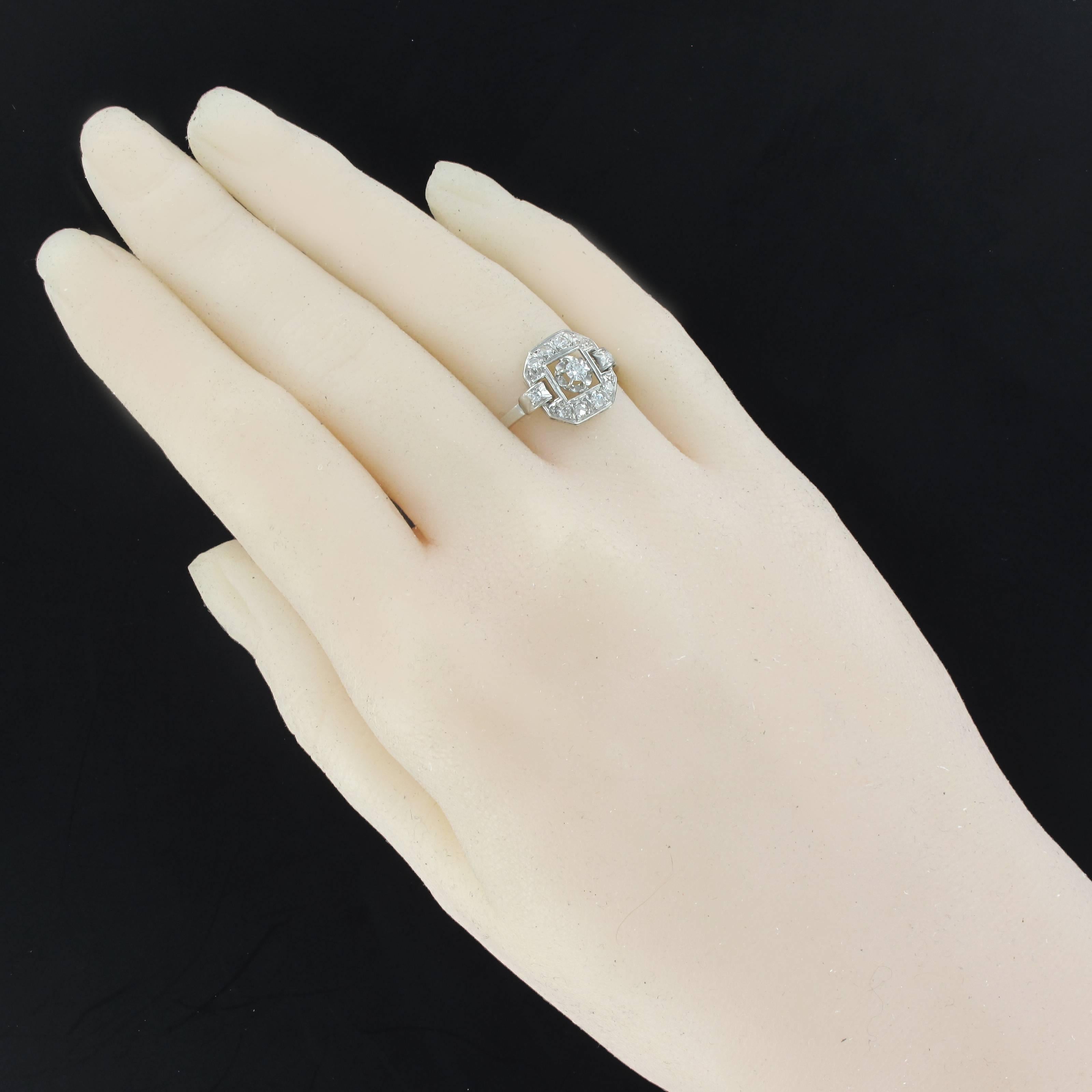 Ring in platinum, dog's head hallmark.
Hexagonal shape, this lovely antique art deco ring is set with claws on its top of an antique cut diamond on a openwork decor and set with 10 diamonds.
Main diamond weight: about 0.10 carat, total weight of