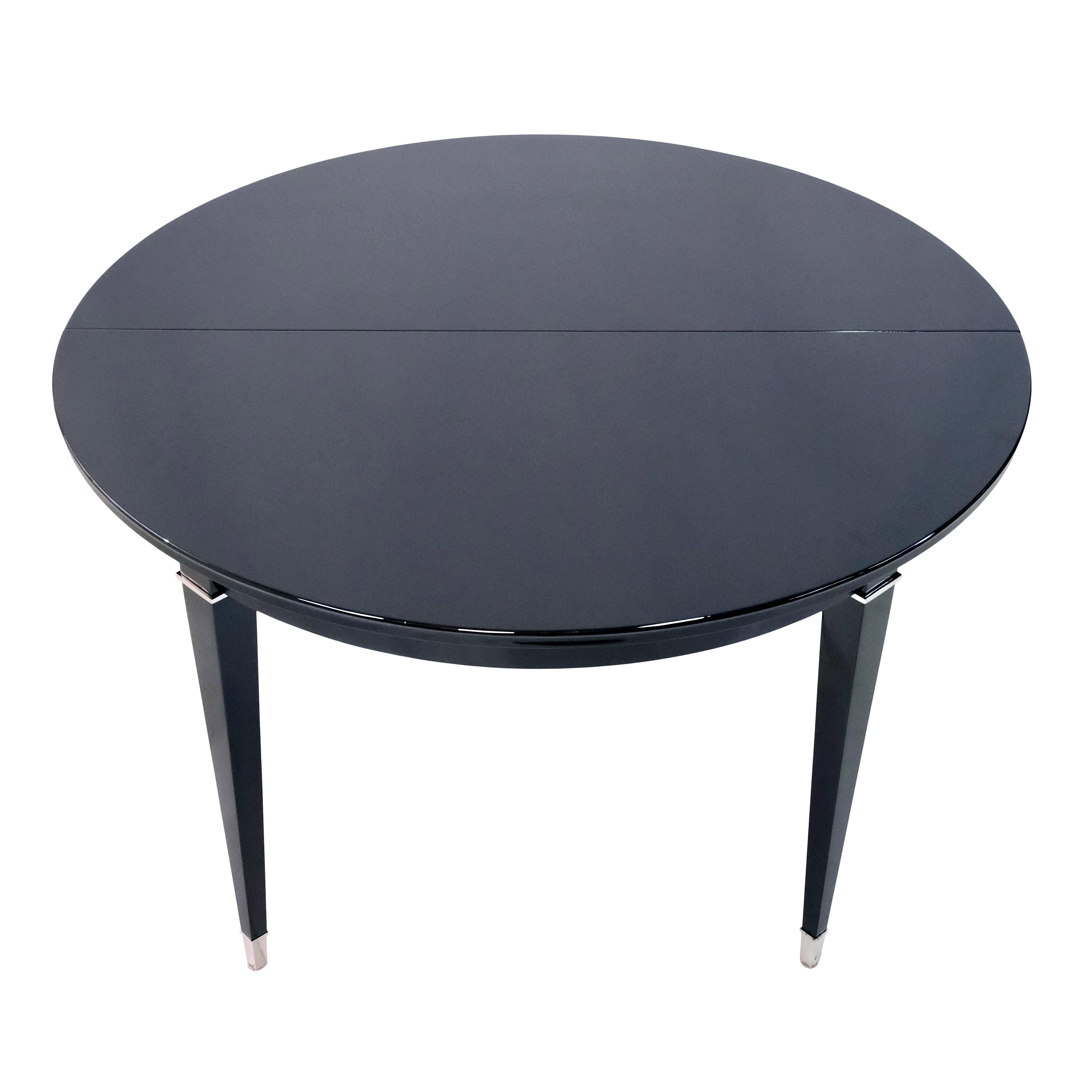 Round dining table with extension (50cm) 
Wood in Black Piano Lacquer 
Fittings, nickeled

Original Art Deco, France 1930s

The table can also be used as a nice center table at your entrance. 

Dimensions:
Diameter: 115 cm 
Height: 73