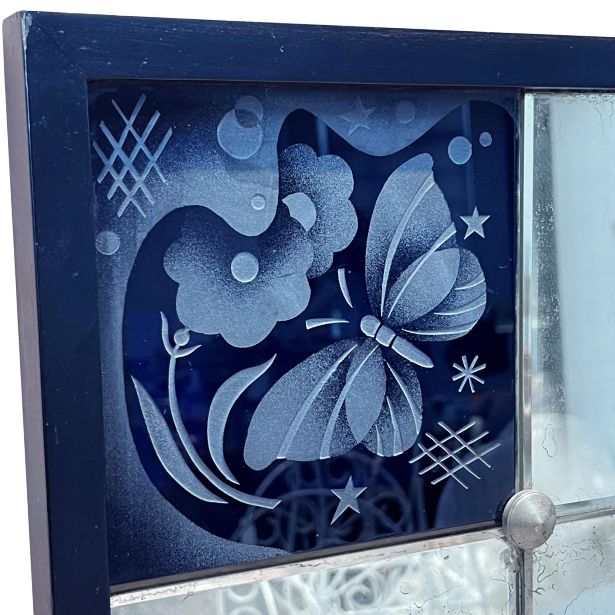 This sectional mirror was made in France in the 1930s. Art Deco in style - this piece would grace any room in the home and would also be a lovely piece for a boutique hotel suite too. 

It is beautifully decorated with six blue glass panels which