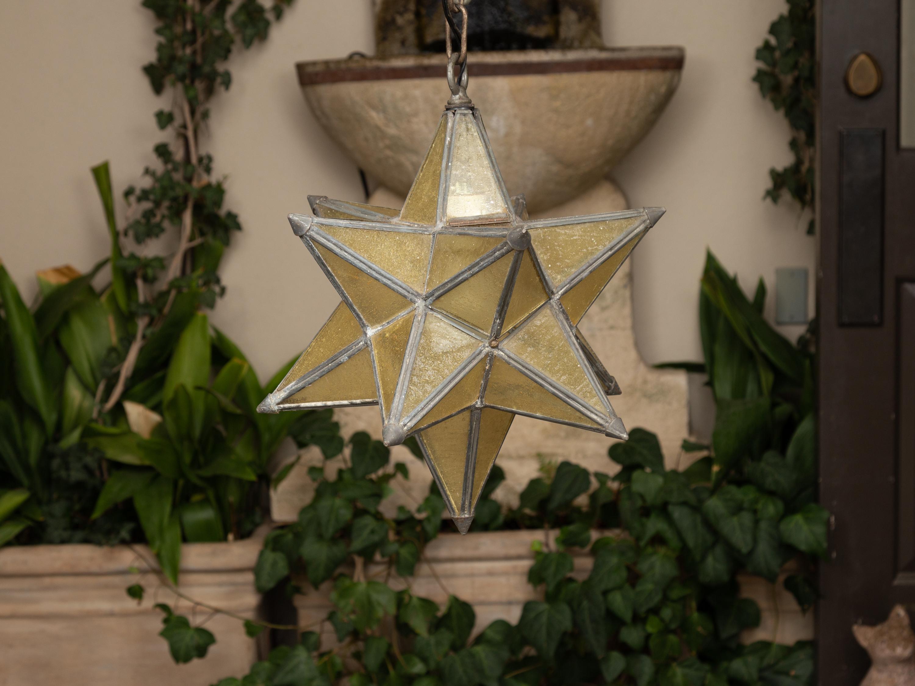 A vintage French Art Deco period star light fixture from the first half of the 20th century, with metal frame and light gold-colored glass panels. Born in France during the second quarter of the 20th century, this small French light fixture features