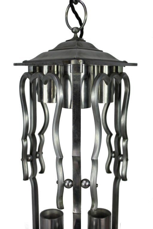 A French lantern in polished steel. Triangular in form with provision for three lights above.