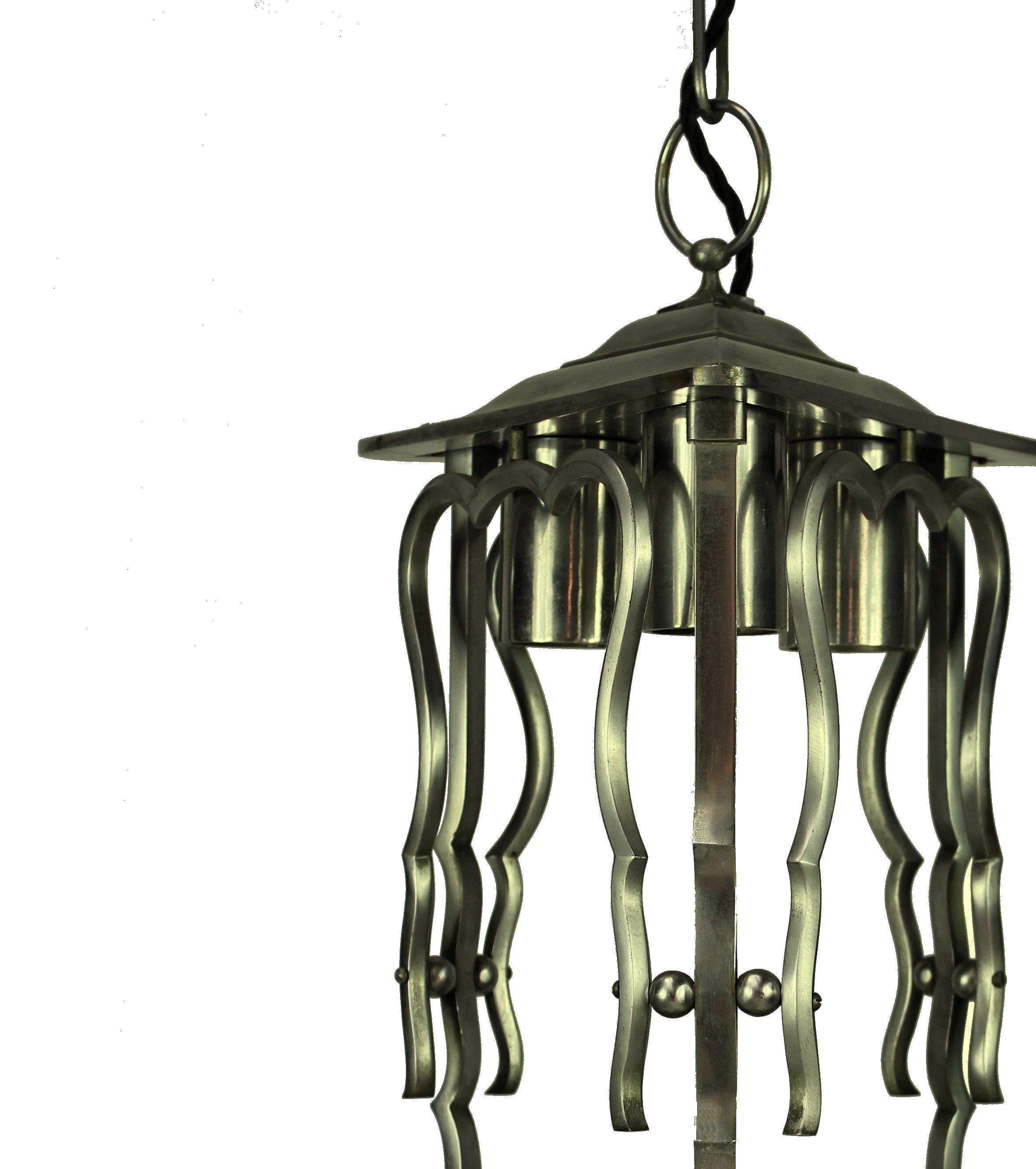 A French lantern in polished steel. Triangular in form with provision for three-light above.