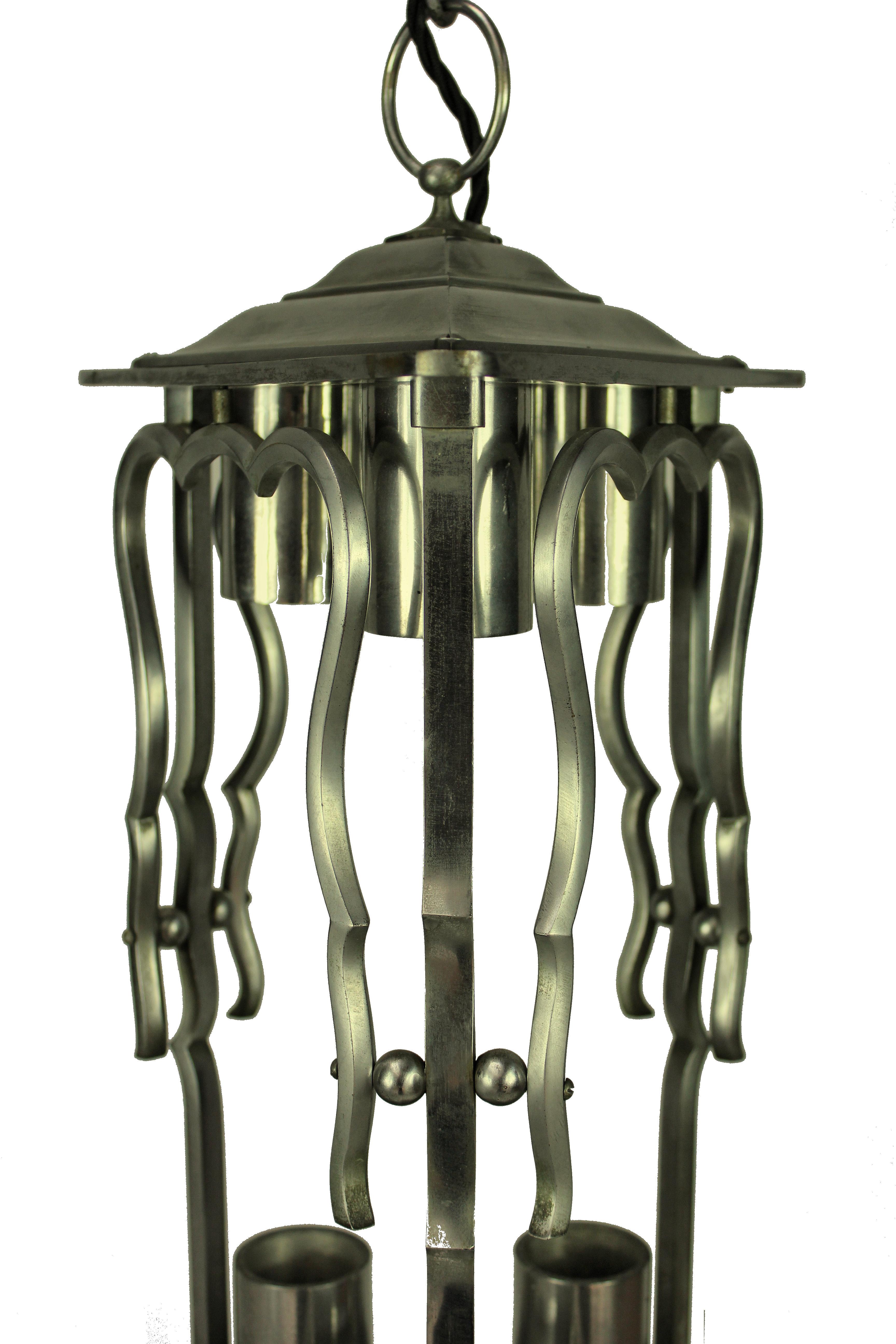 A French lantern in polished steel. Triangular in form with provision for three-light above.