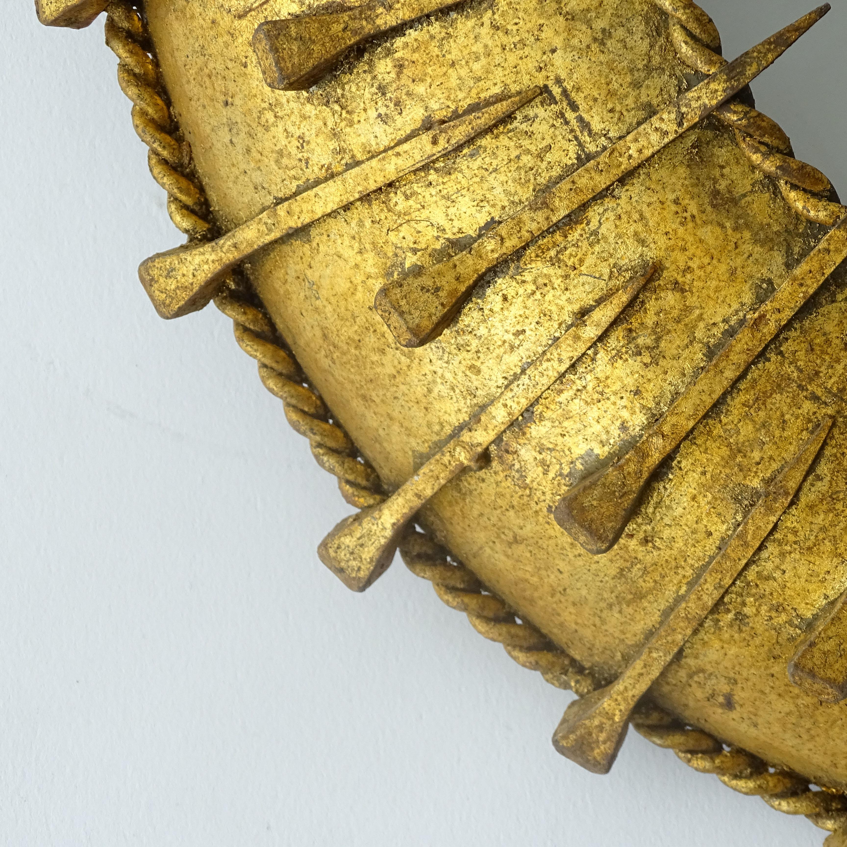 French 1930s Surrealist Sunburst light fixture in gilt iron and nails.