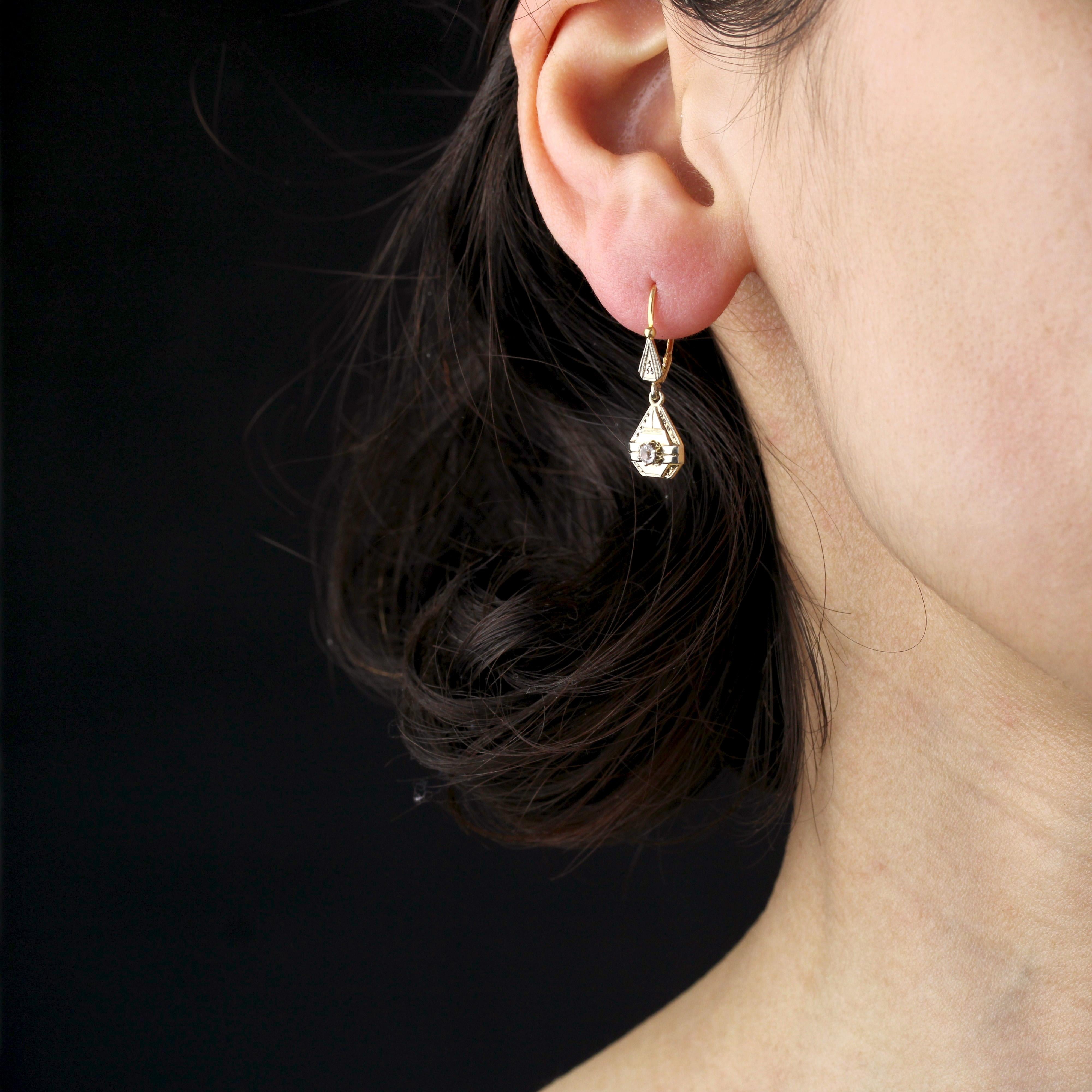 For pierced ears.
Earrings in 18 karat yellow and white gold, eagle head  and rhinoceros hallmark.
These antique yellow gold geometric-shaped lever-back earrings are finely chased with millegrain decorations and claw-set with a white sapphire in the