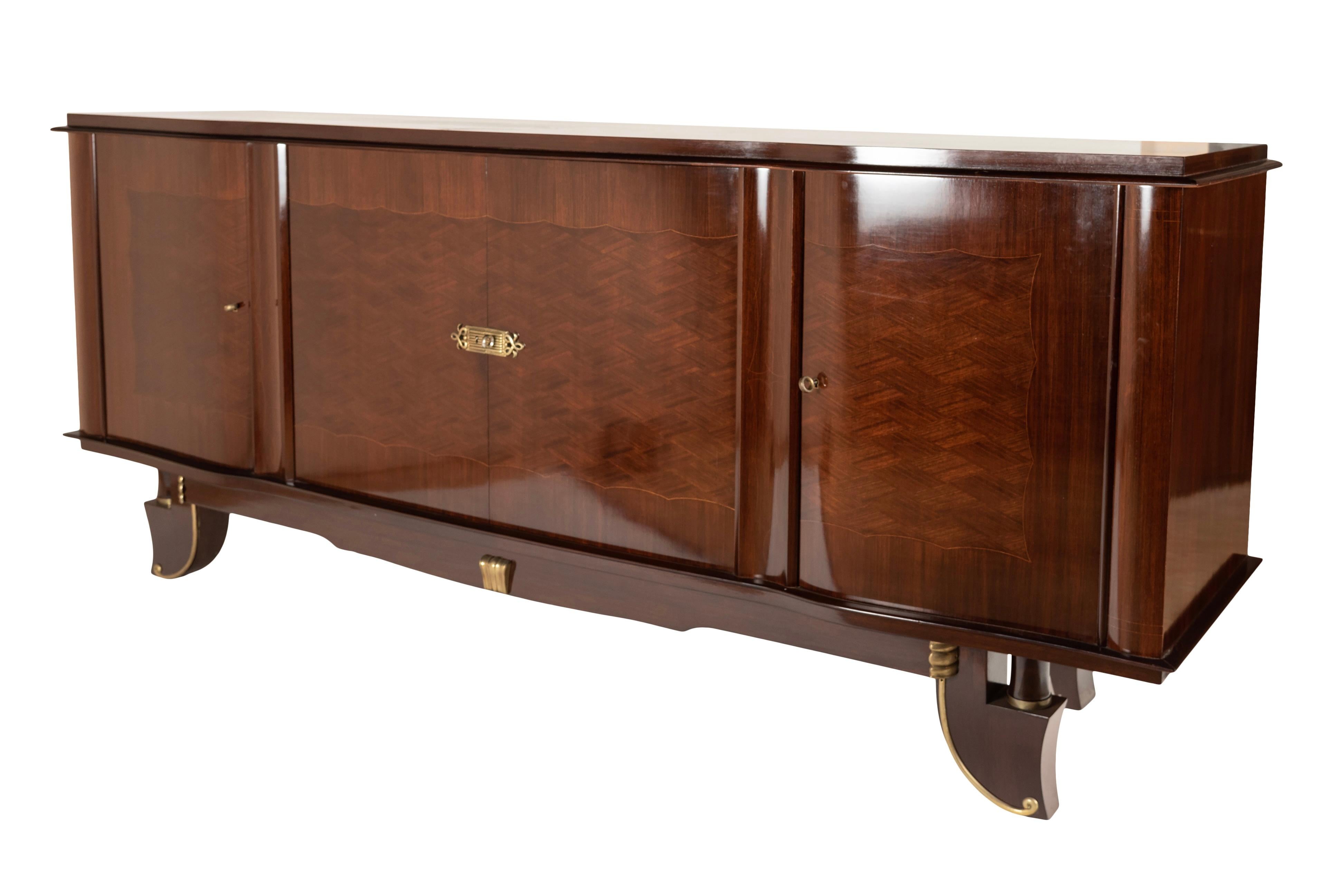This exquisite sideboard dates back to the 1940s and embodies the timeless elegance and sophistication of French design from that era. Every detail has been meticulously crafted, from the finely worked brass fittings to the intricate appliqués.

The