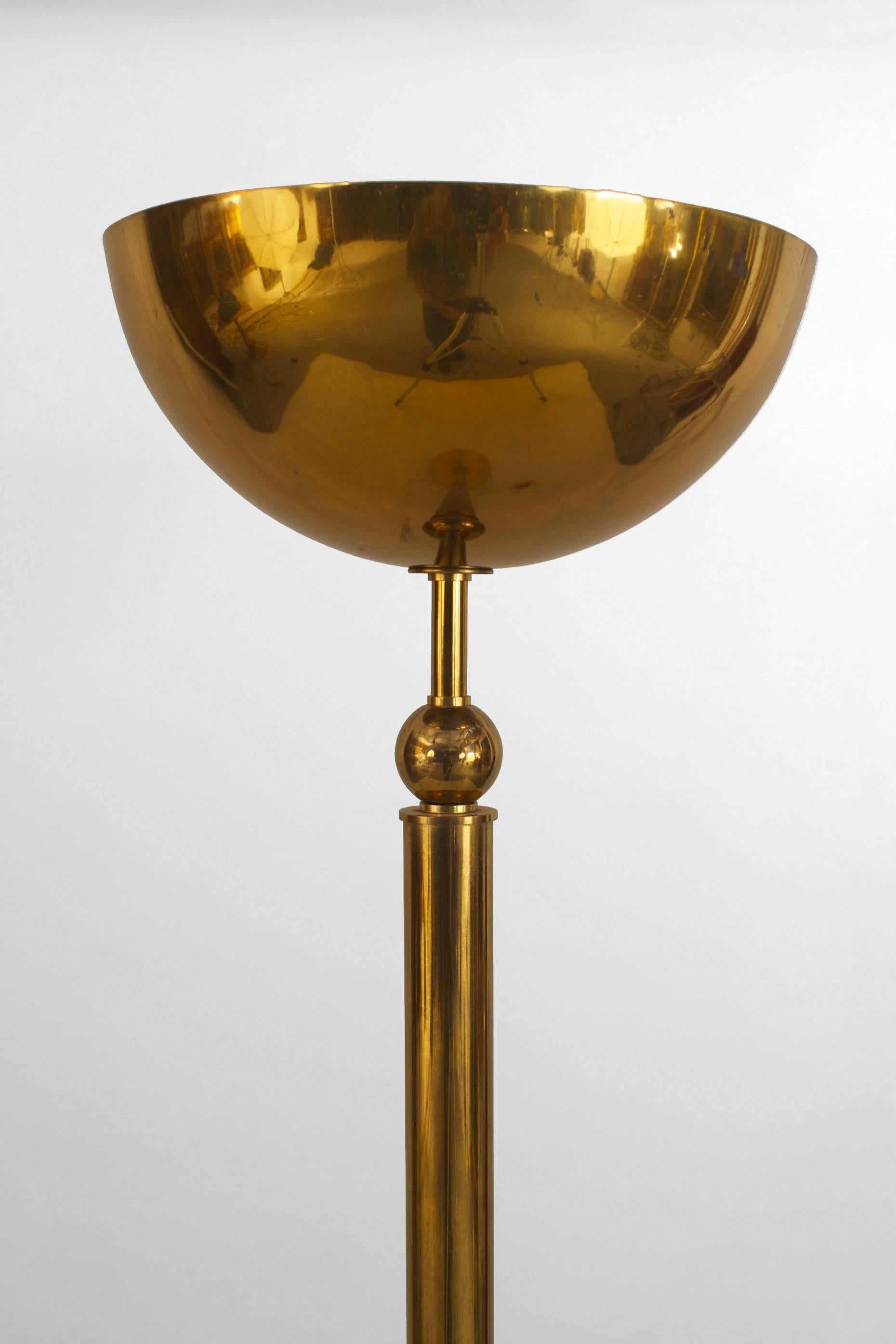 French 1940s brass floor lamp with a cylindrical shaft supporting a large dome and resting on a round base.
