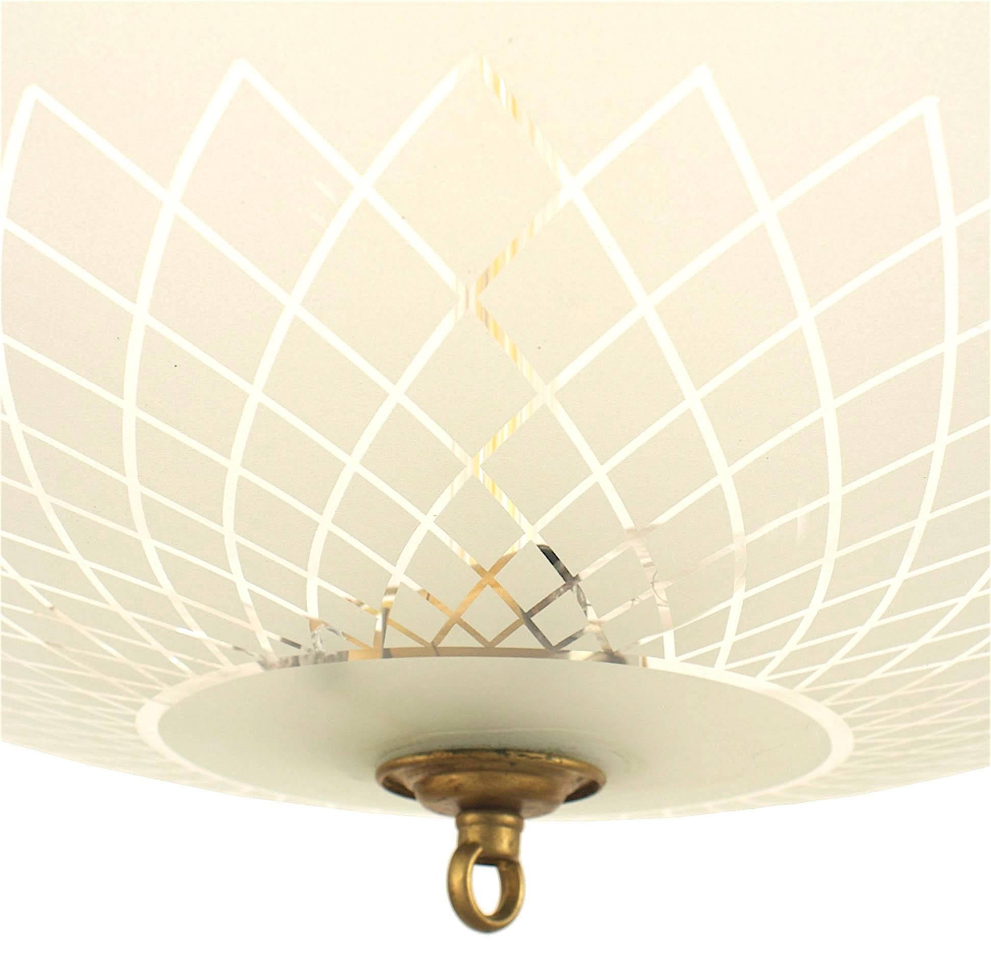 French 1940s chandelier with a large round frosted glass bowl shade having a geometric woven and scalloped design edge supported by a fluted glass stem with a brass finial bottom.
 