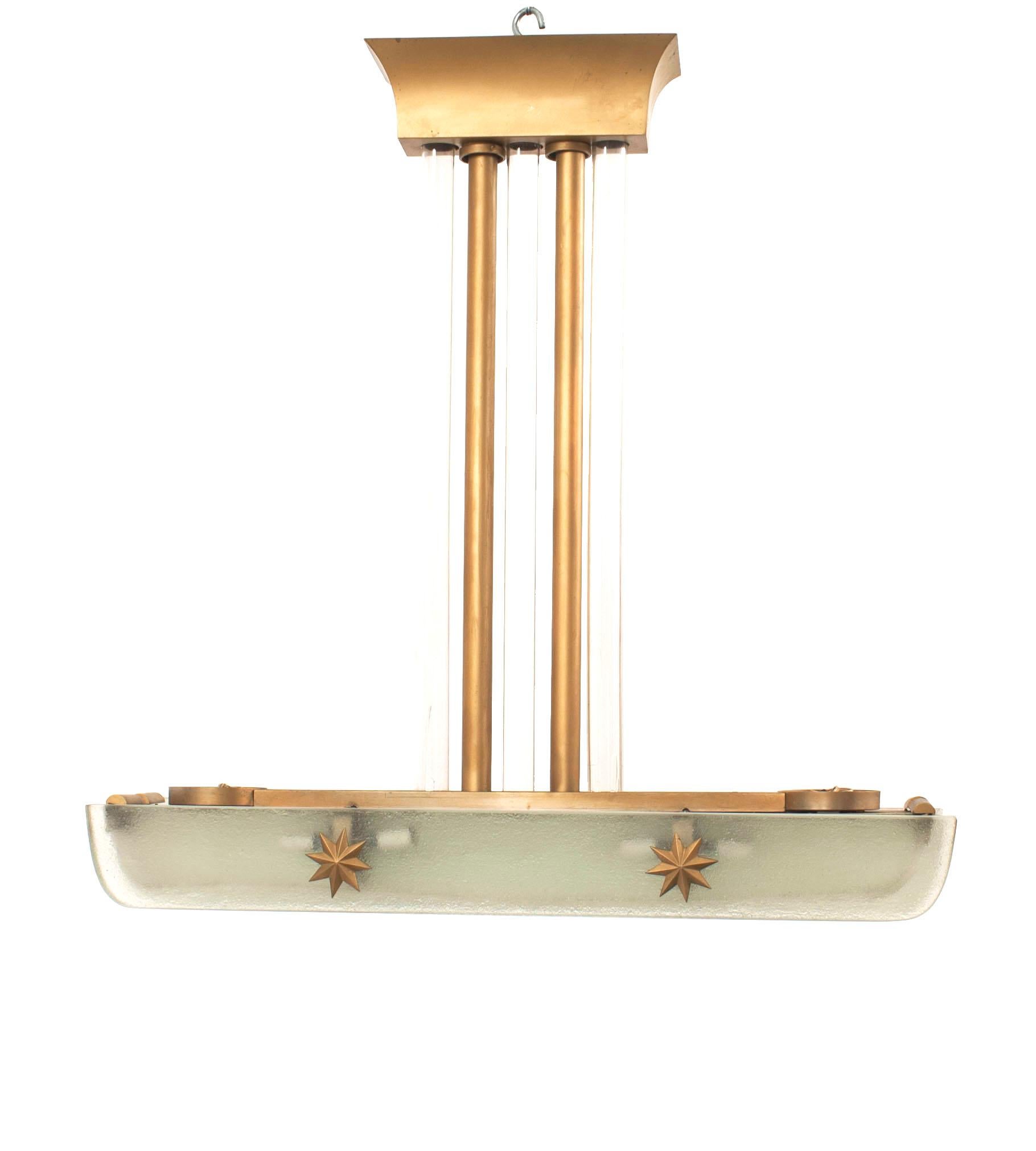 French (1940s) chandelier with lucite horizontal panels separated by 3 Saint-Gobain Glass panels with gilt star trim and suspended by a gilt metal and tubular glass center extension.
    