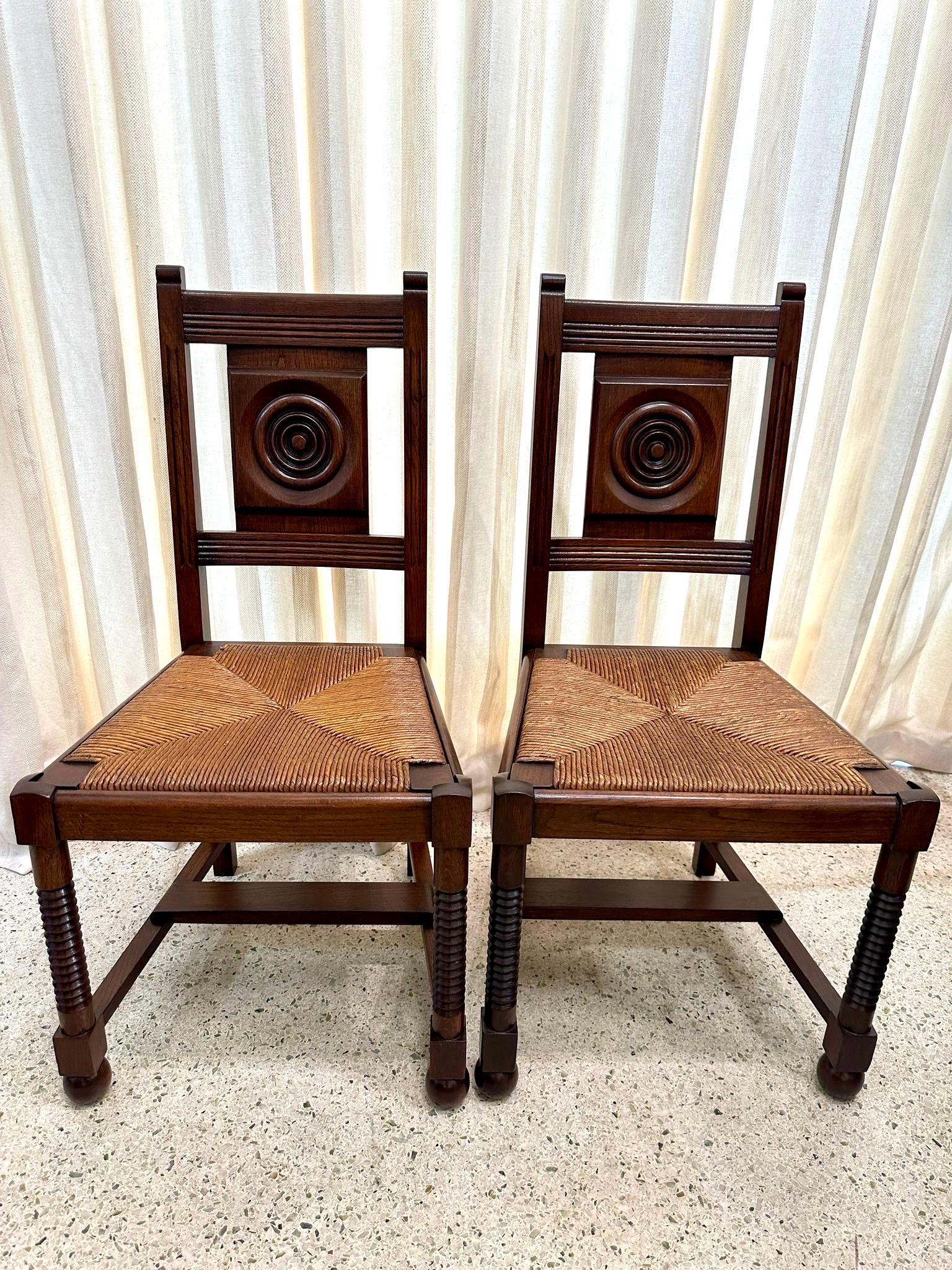 Amazingly restored vintage Set of 4 Charles Dudouyt Oak Chairs with rush seats.  NOTE:  we also have the matching dining table with extensions available in separate listing.  Please inquire.

A bit of timeless sophistication with this set of 4