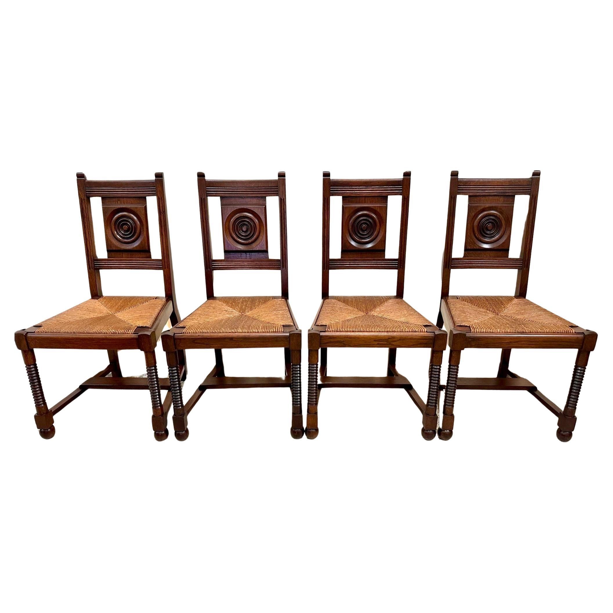 Chaises de salle à manger en chêne et jonc Charles Dudouyt des années 1940 - Lot de 4 en vente