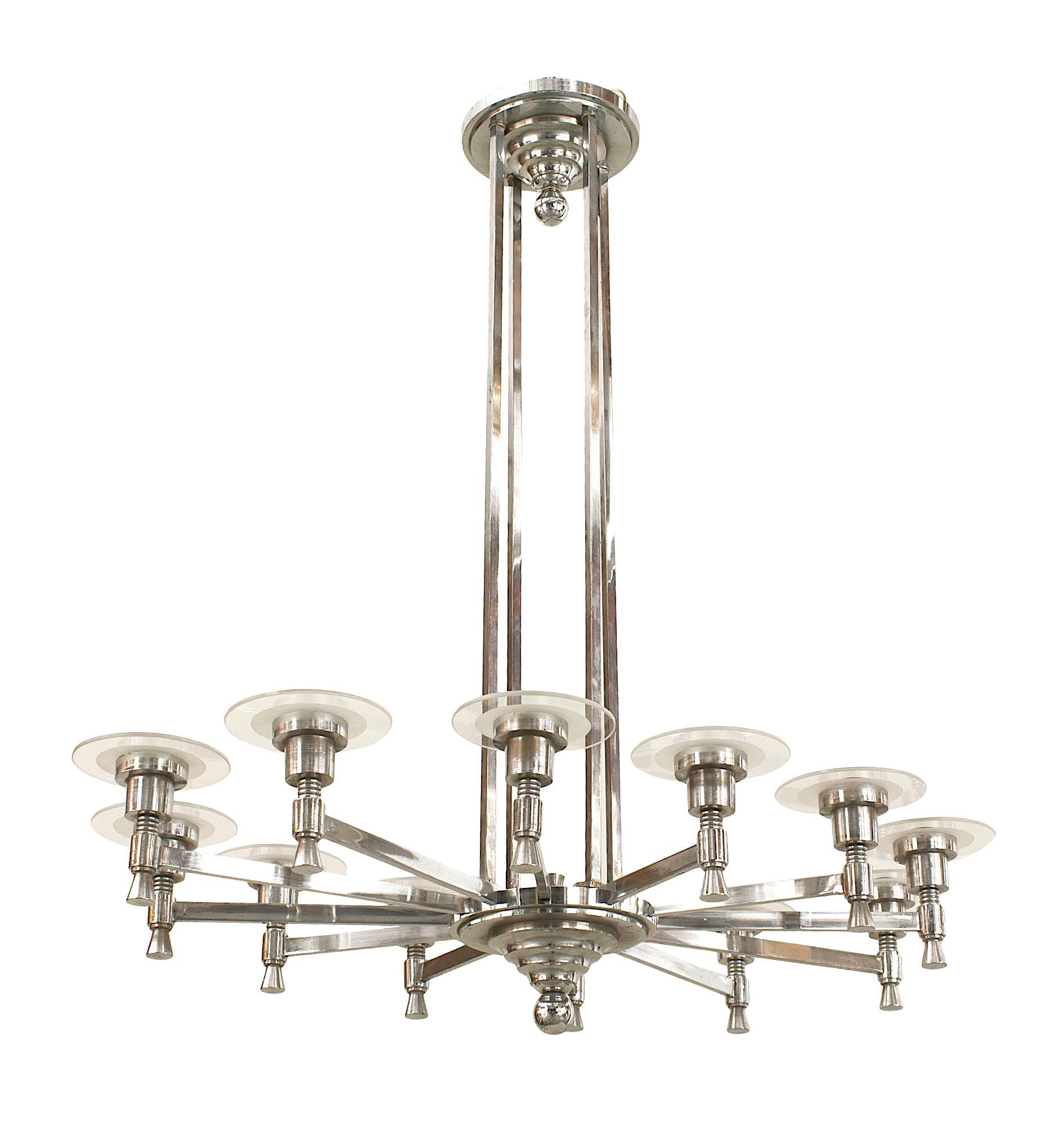 French 1940s chrome plated oval shaped Modernist 12 arm chandelier supported by 4 center post shafts with clear & frosted Lucite bobeches and a tiered finial bottom.

