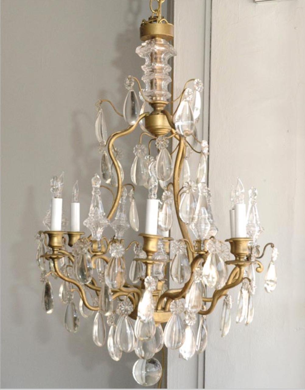 Elegant chandelier by Maison Baguès. Six lights with clear crystal tear drops, daggers and rosettes.