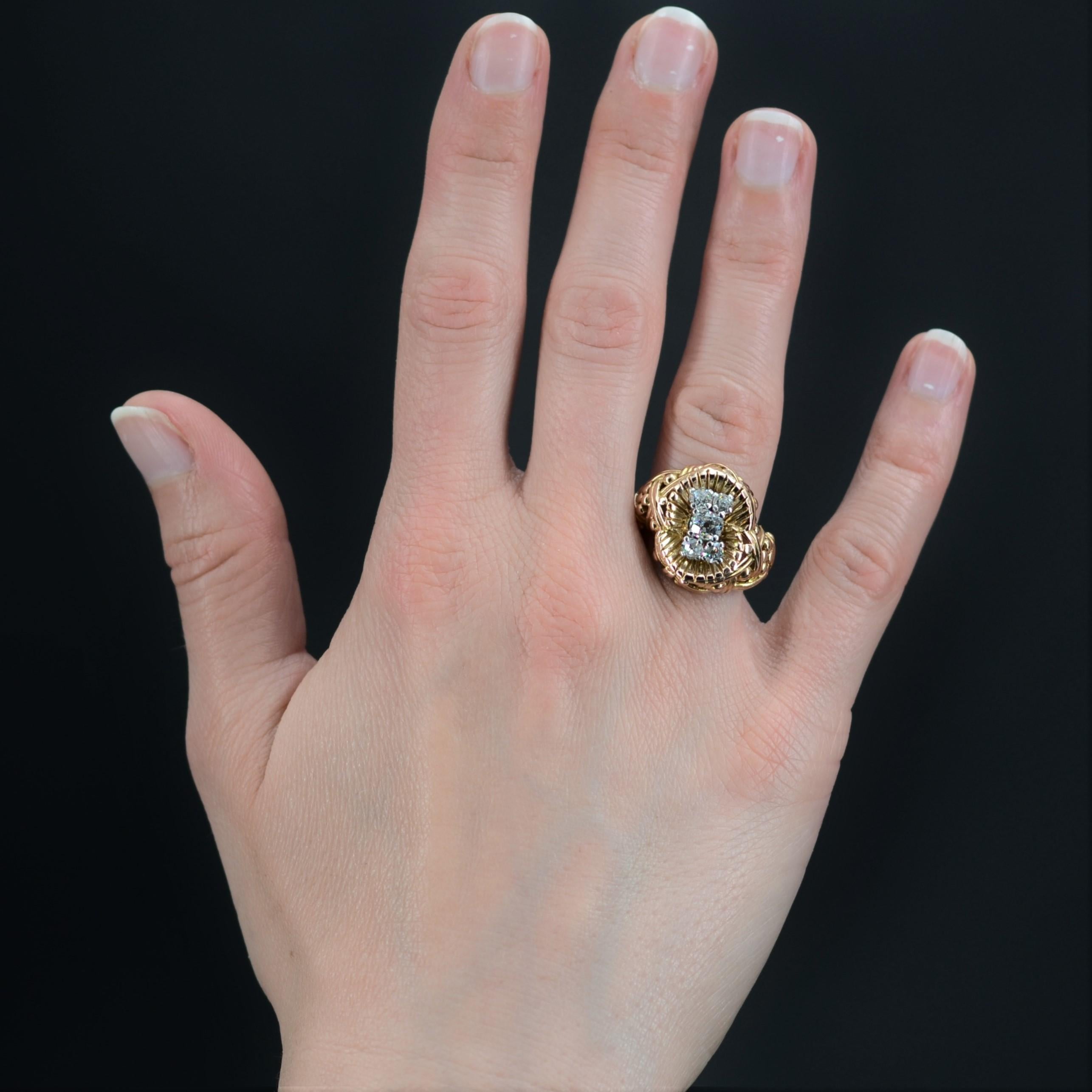 Ring in 18 karat yellow gold, eagle head hallmark, and platinum, dog head hallmark.
Massive antique ring, it is decorated on its top, and retained with platinum claws, of 5 antique cushion-cut diamonds, the one of the center being more important.