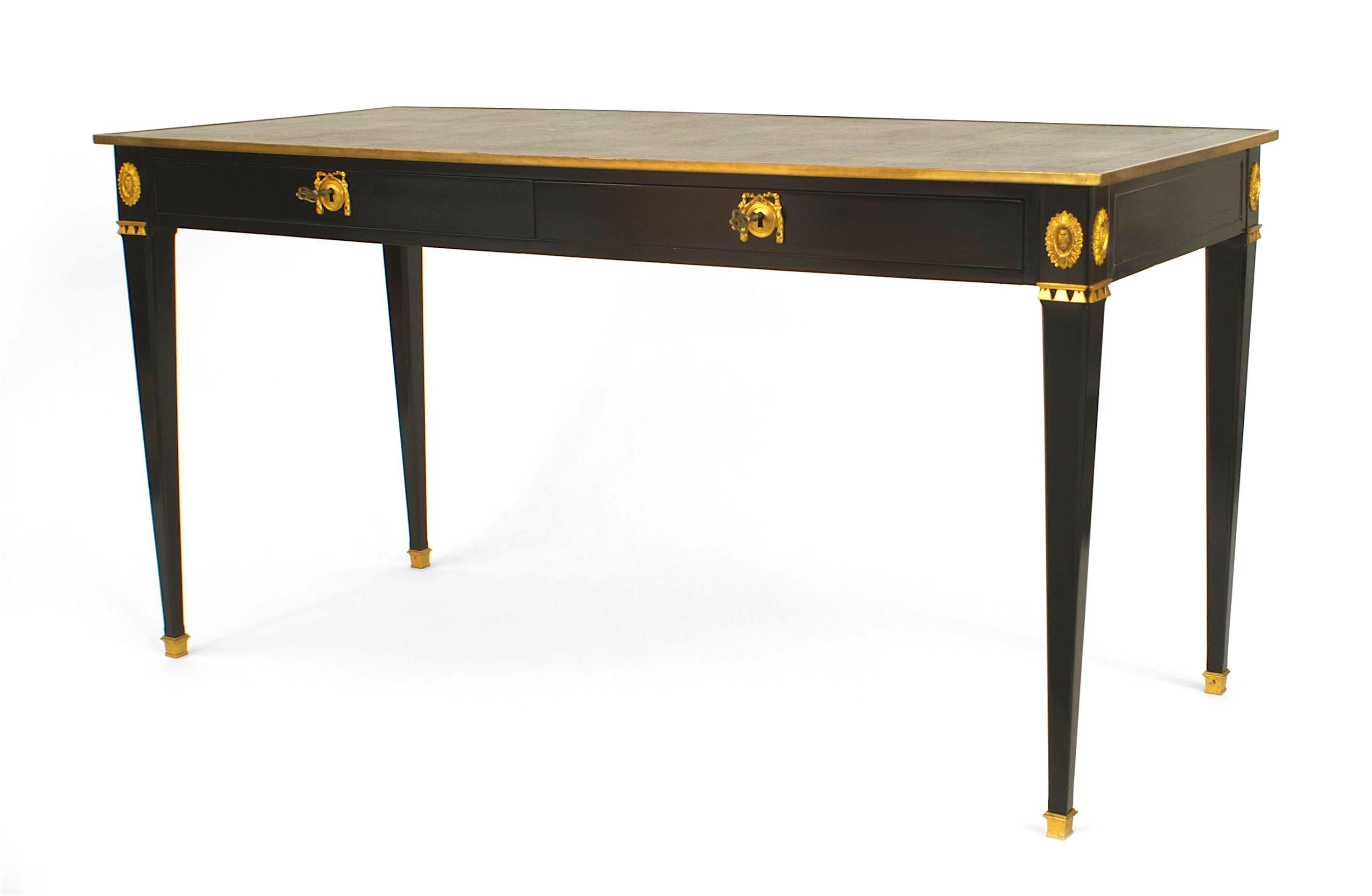 French 1940s ebonized and rectangular table desk with bronze edge and trim having two drawers over a black leather top (stamped: JANSEN).

Maison Jansen was a Paris-based interior decoration office founded in 1880 by Dutch-born Jean-Henri Jansen.