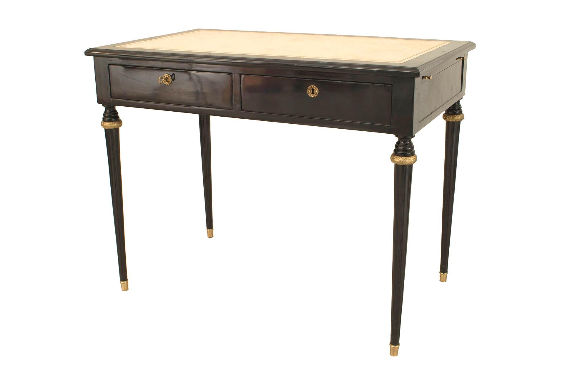 French 1940s ebonized and rectangular table desk with gilt trim having two drawers and a top with two side slides covered in off-white leather (attributed to Jansen).

Maison Jansen was a Paris-based interior decoration office founded in 1880