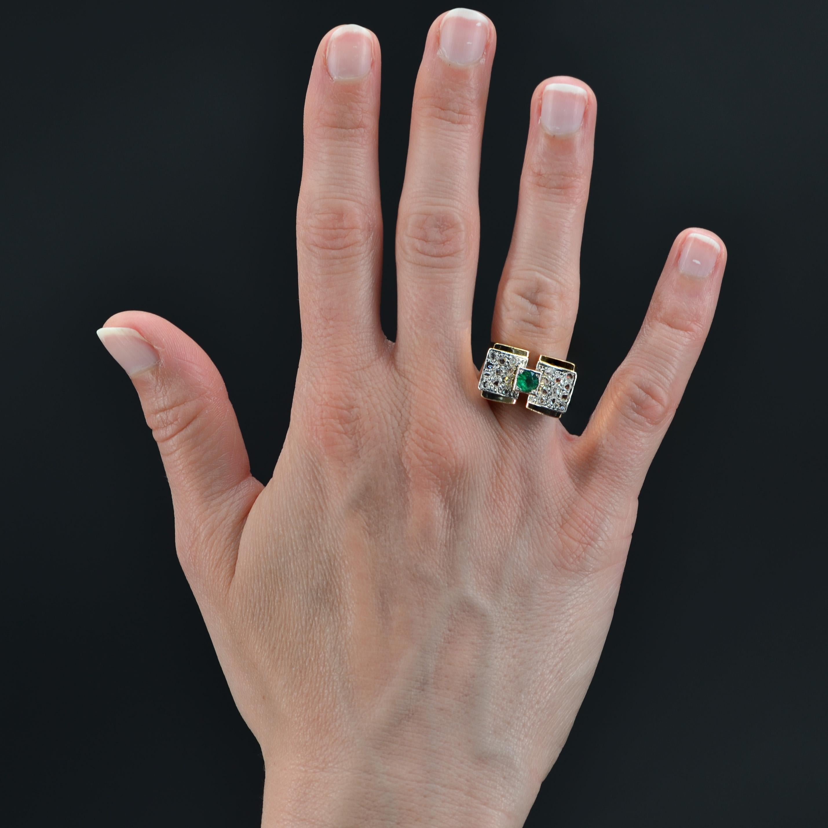 Ring in 18 karat yellow gold, eagle head hallmark, and platinum, dog head hallmark.
Iconic model of the 1940s, this tank ring is set with a round emerald of a vivid and intense green in the center, with a pavement of rose-cut diamonds on both sides
