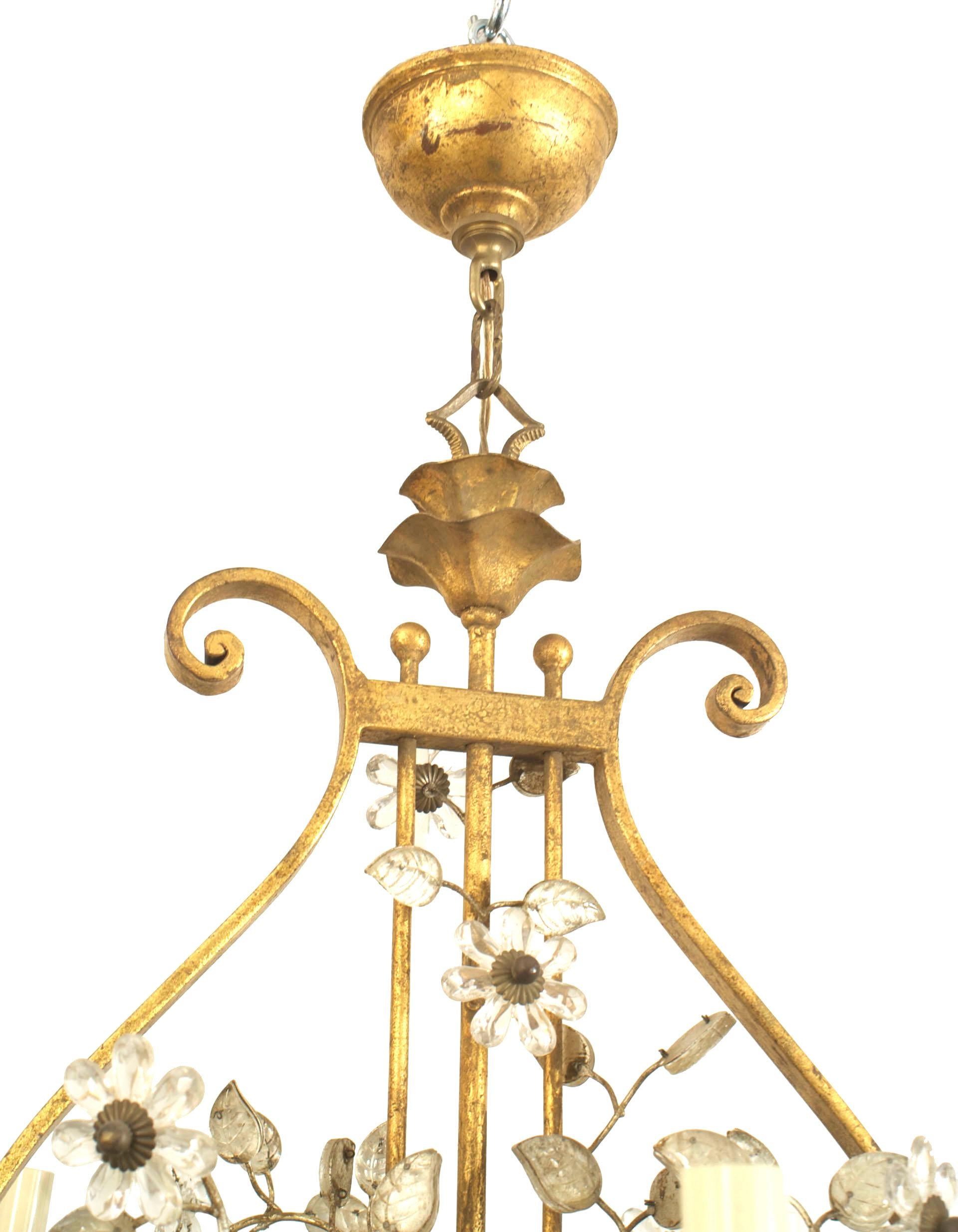 French (1940's) gilded iron chandelier with 6 scroll design arms emanating from a lyre form center and surrounded by silver gilt glass leaves & flowers with a frosted glass bottom shade. (by BAGUES)
