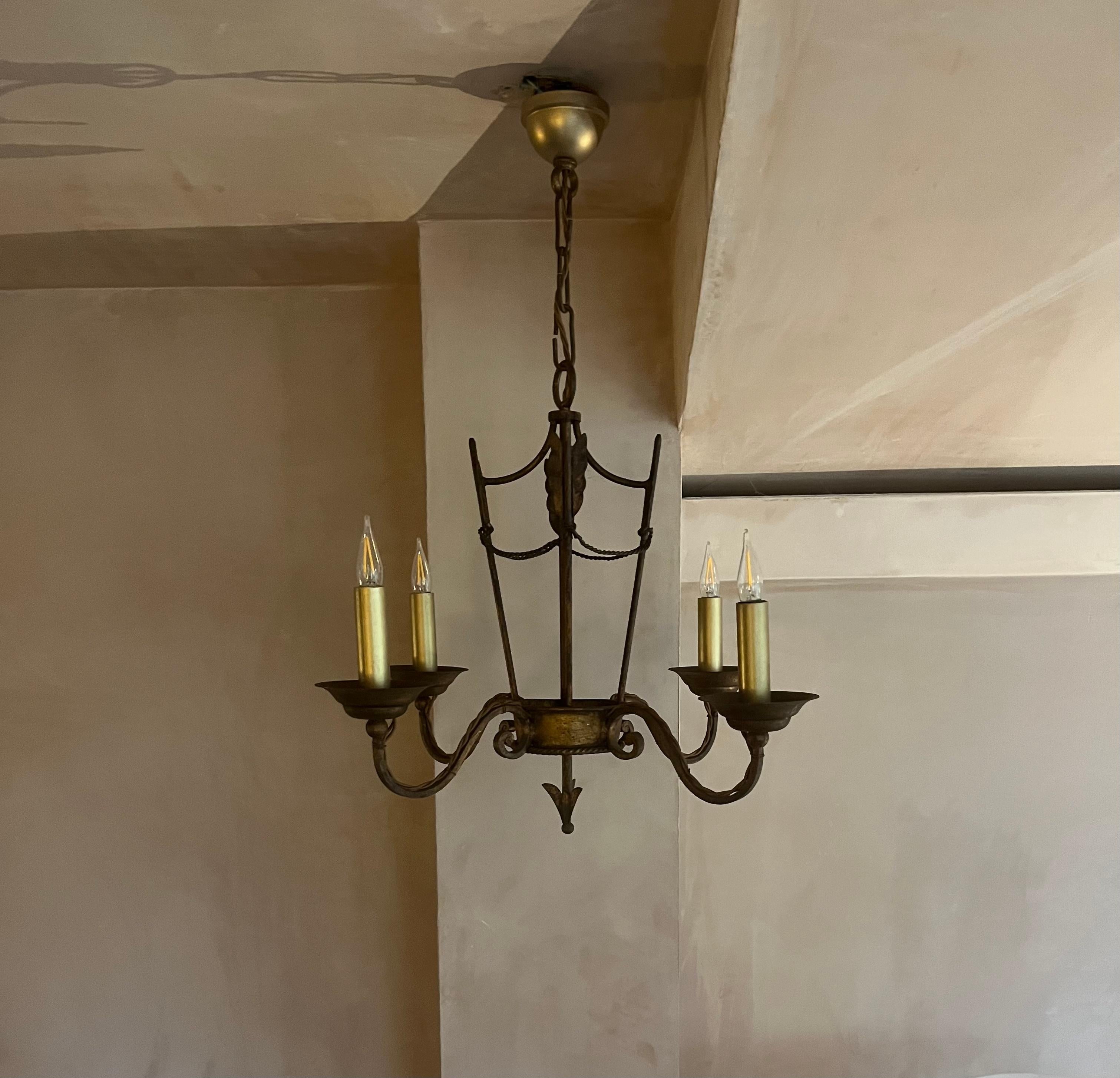 A very elegant and well made gilded iron small chandelier in the style of Maison Jansen French c.1940’s. Rewired with gold coloured candles leaves. 