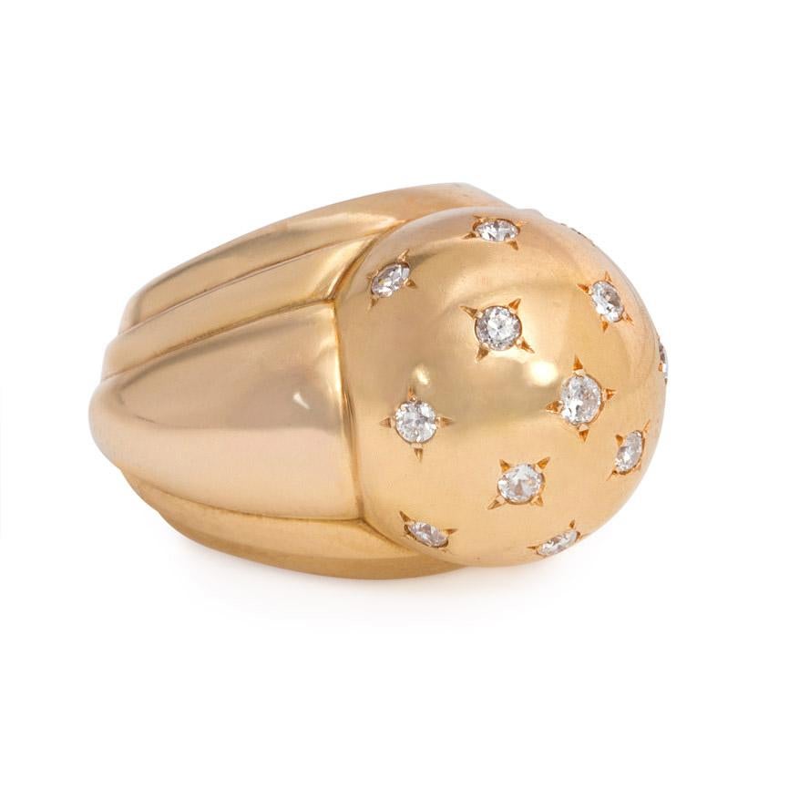 A Retro rose gold bombé ring centering on a dome studded with star-set diamonds, with stepped tapering shoulders, in 18k.  France

Current size: 5 1/4 (Minor resizing is possible; please contact us with any questions.)
Sits approximately 1.5cm above