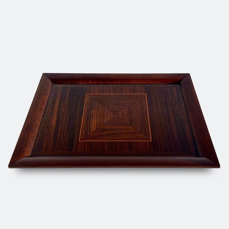 A French 1940s rectangular serving tray. 
Surrounded with a raised curved edge and decorative cross banding to the interior border. The central square is beautifully formed from four quadrilateral triangle veneers adding a subtle geometric twist,