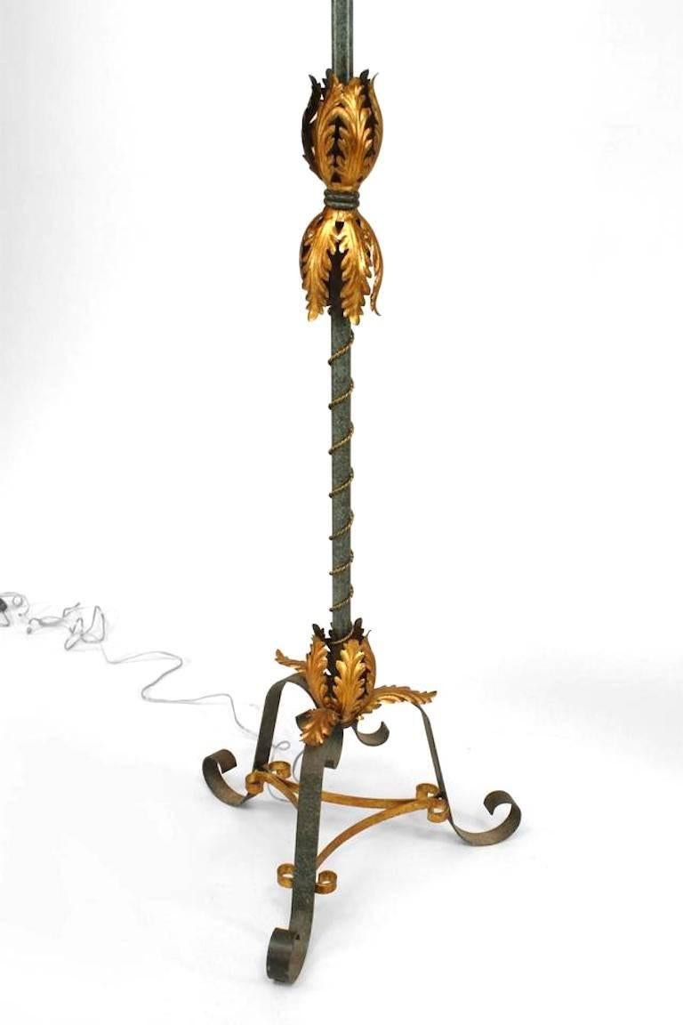 French 1940s iron blue/green patina floor lamp with gilt rope and floral design trim with a triple scroll base connected with a stretcher.
