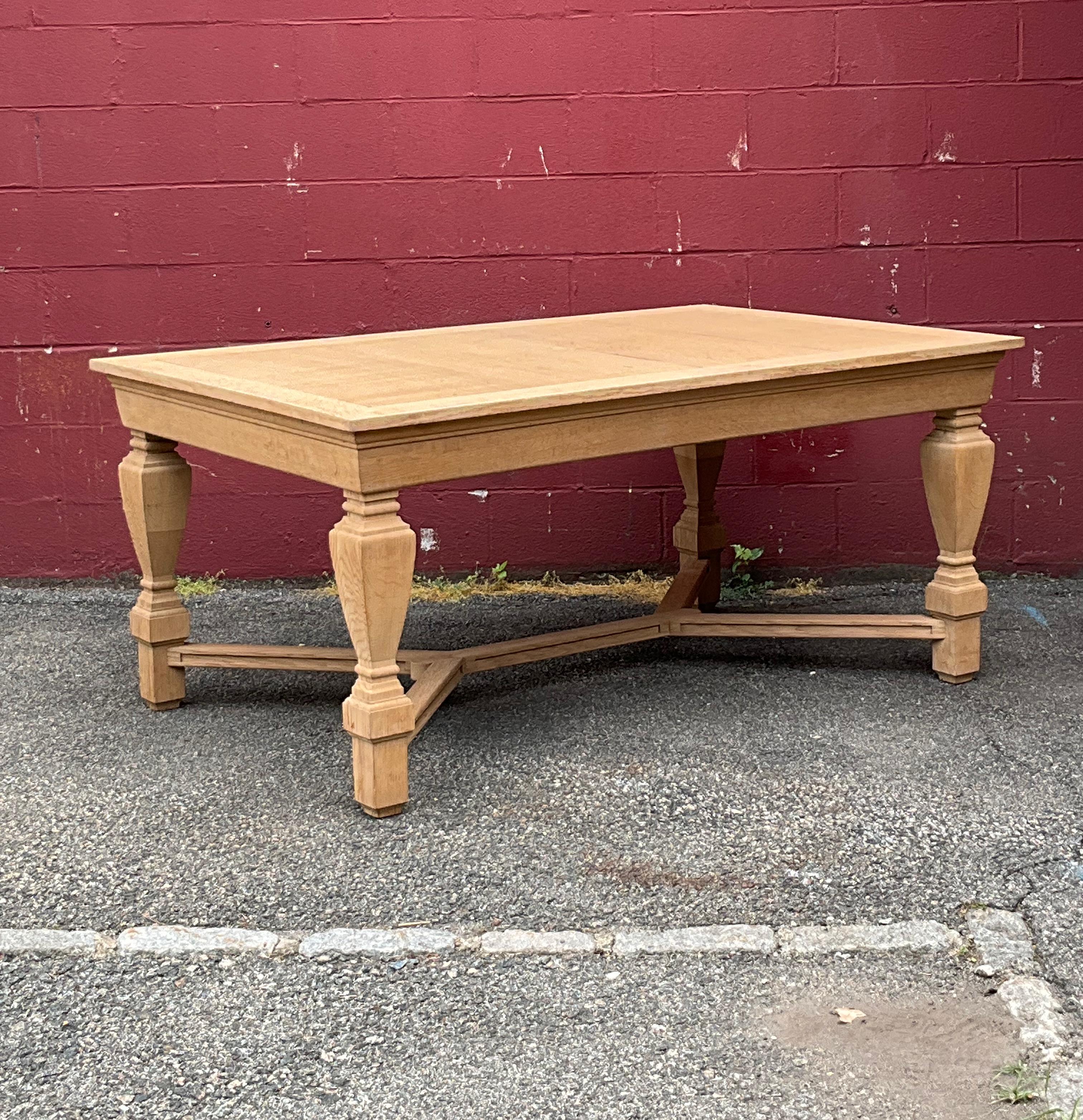 This extraordinary French 1940s oak library table features impeccable craftsmanship from the inset top to the sculptural legs and X shaped stretcher. The table has recently been stripped and bleached and it can be used as is or it can be waxed to