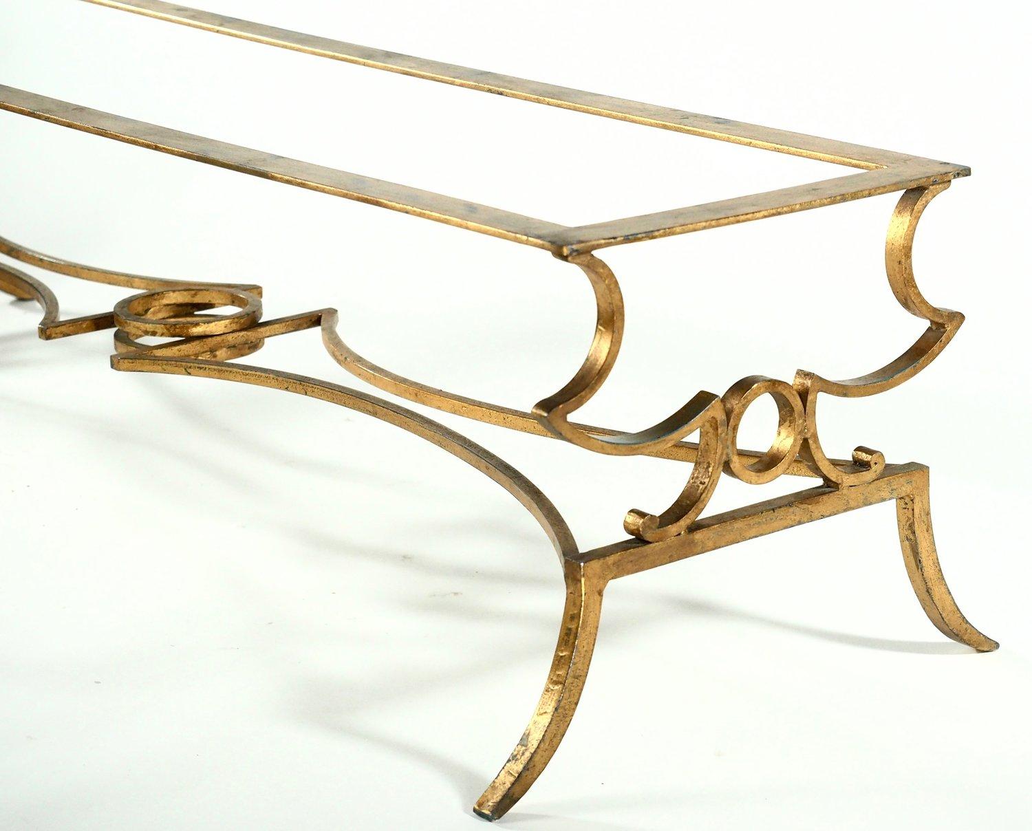French 1940s long, low, gilt forged iron coffee table with glass top.