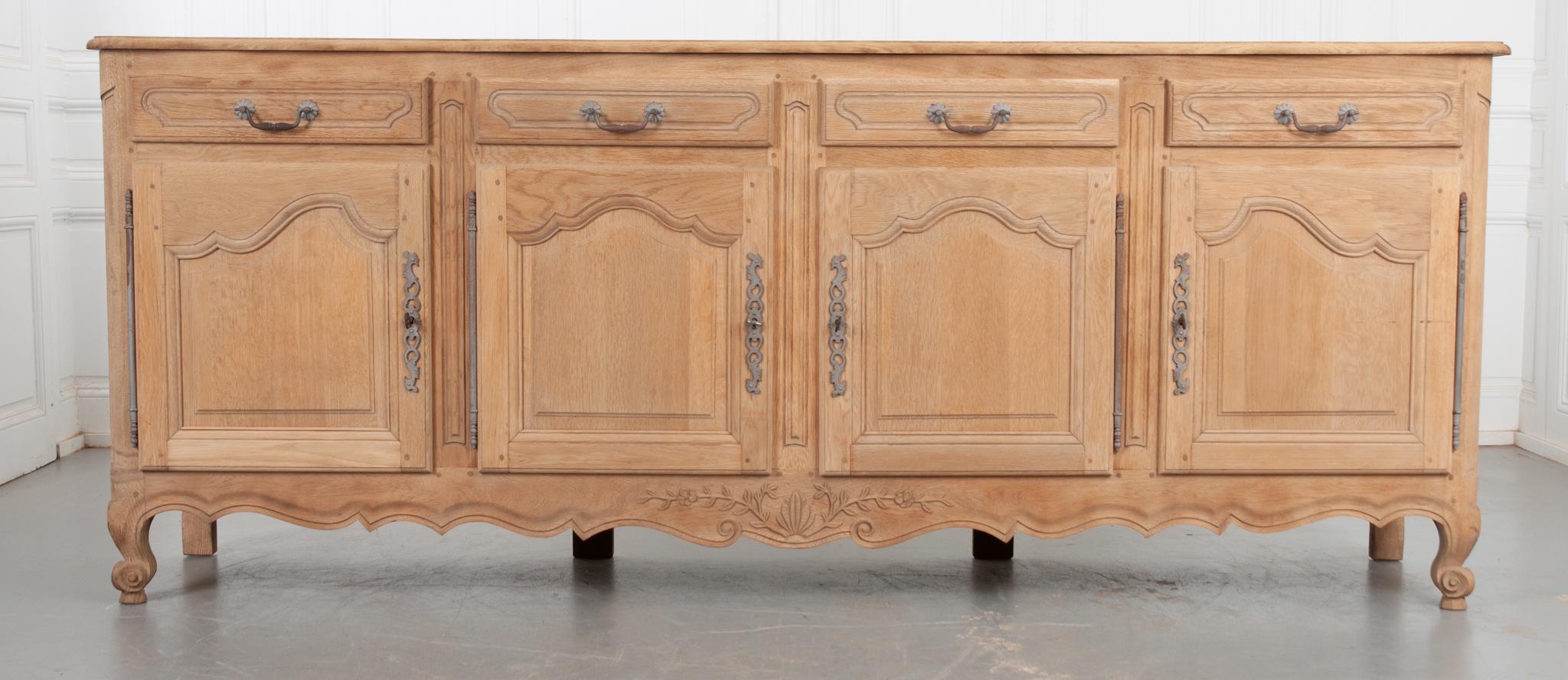 This vintage enfilade was made in the 1940’s in the style of Louis XV of France. The sturdy oak has been sandblasted, giving it a unique finish. Beautiful details throughout this piece include a wonderful top with parquet design and scalloped edge,