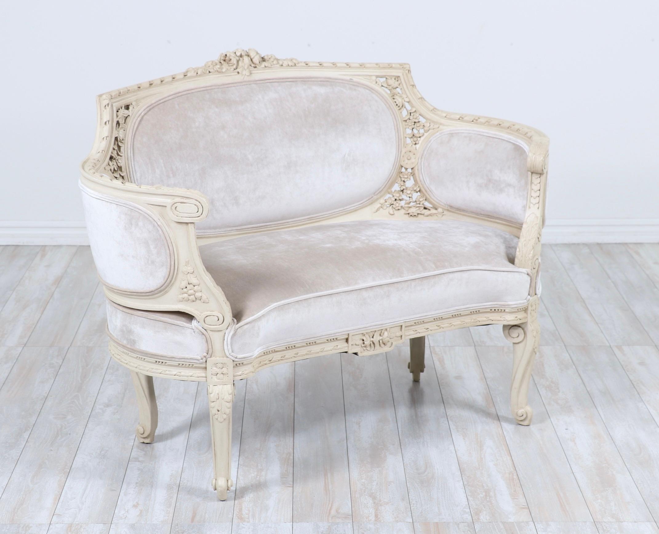 Beautiful, French 1940s painted and carved wood loveseat in the Louis XVI style. 

     This loveseat consists of intricately carved frame which has been newly refinished with a hand applied oyster-white paint. New champagne silk velvet upholstery.