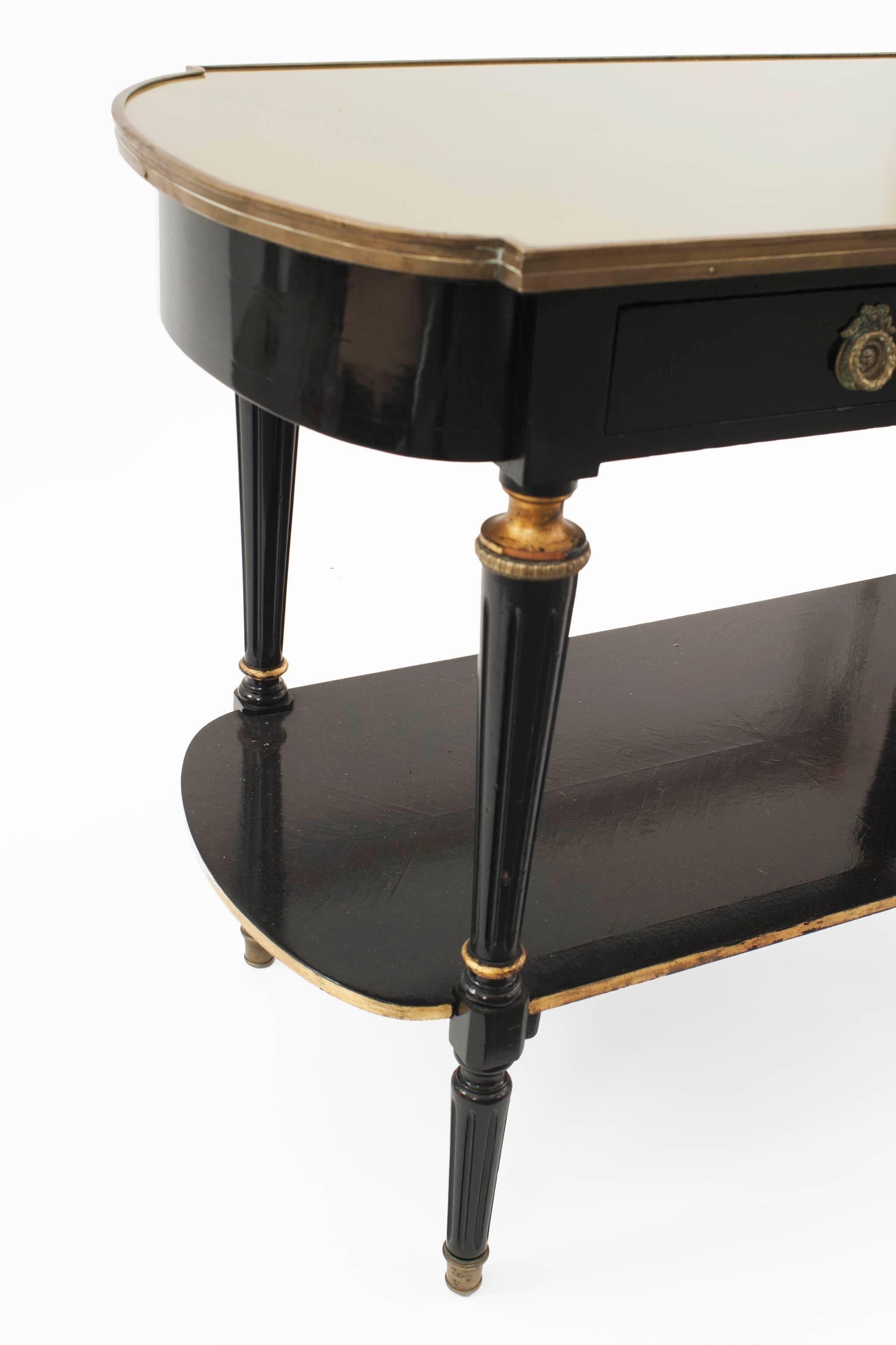 French Louis XVI-style (1940s) ebonized & bronze trimmed 2 tier console table with 2 drawers & 4 tapered round legs connected with a shelf & an inset gold glass top. (stamped: JANSEN)
