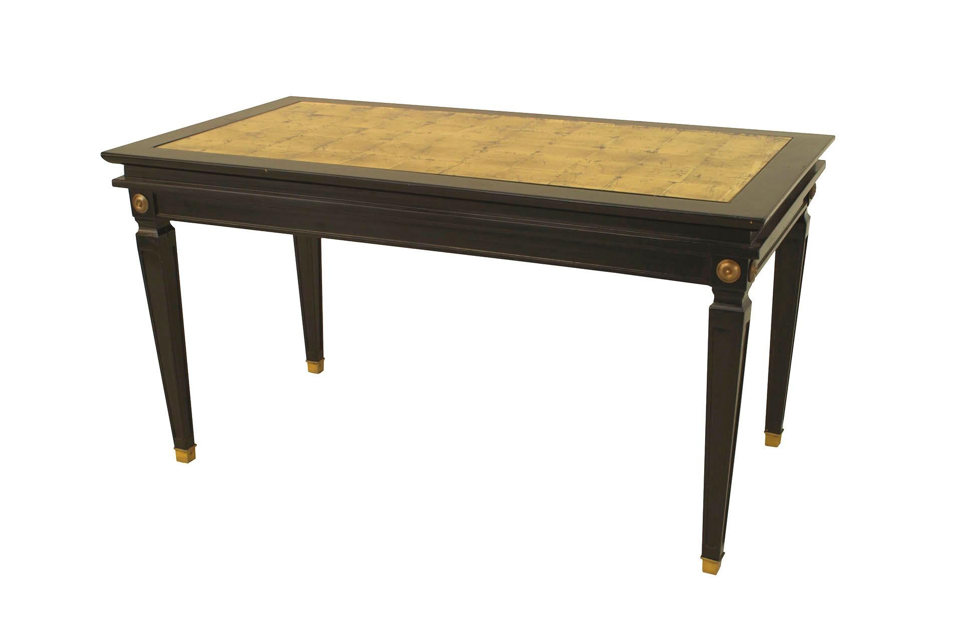 French, 1940s (Louis XVI style) ebonized and gilt trimmed coffee table with tapered square legs and gilt glass inset top (stamped: JANSEN).

Maison Jansen was a Paris-based interior decoration office founded in 1880 by Dutch-born Jean-Henri Jansen.