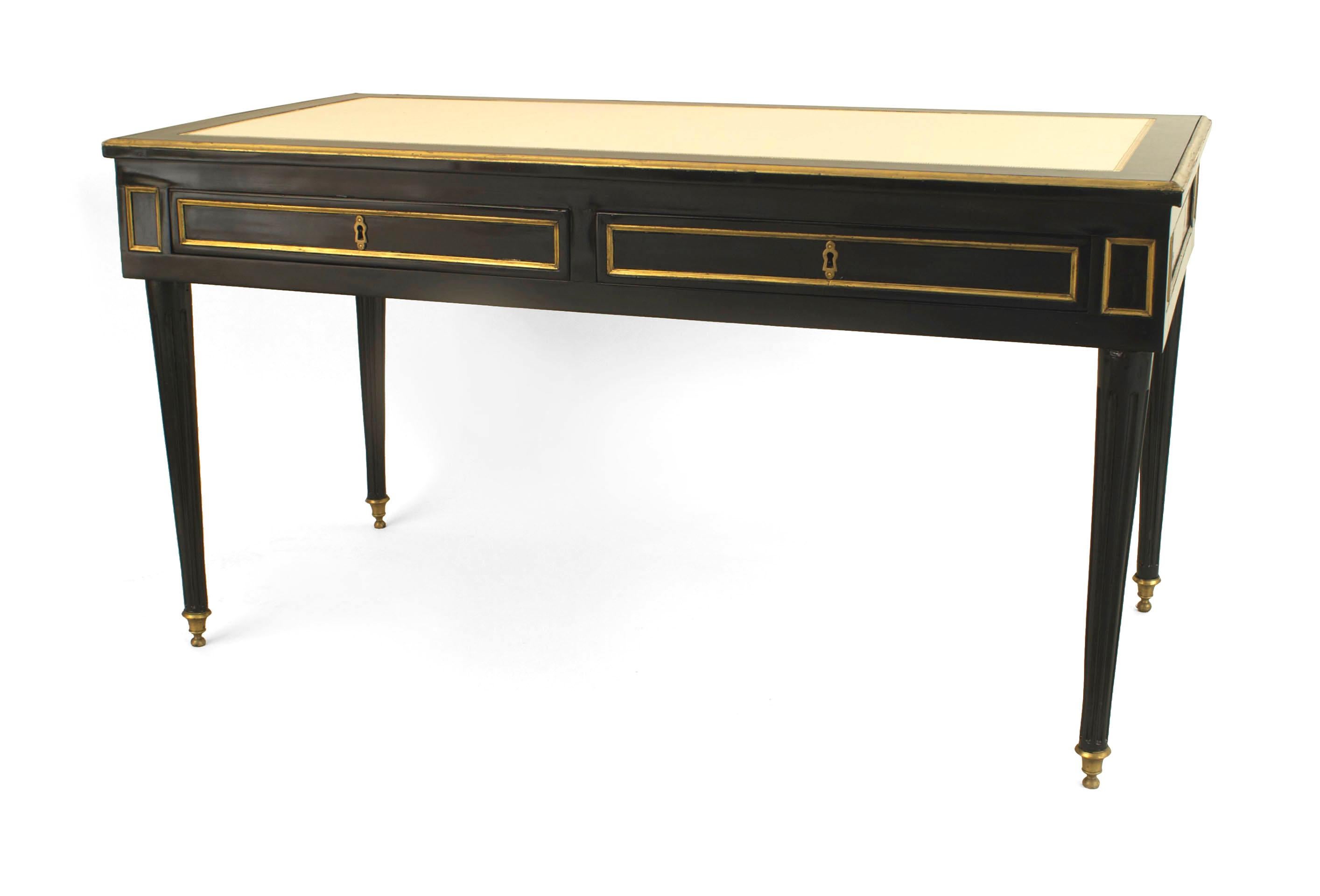 French 1940s ‘Louis XVI style’ ebonized table desk with gilt bronze trim and two large drawers under an inset leather top with a bronze edge. Attributed Jansen.

Maison Jansen was a Paris-based interior decoration office founded in 1880