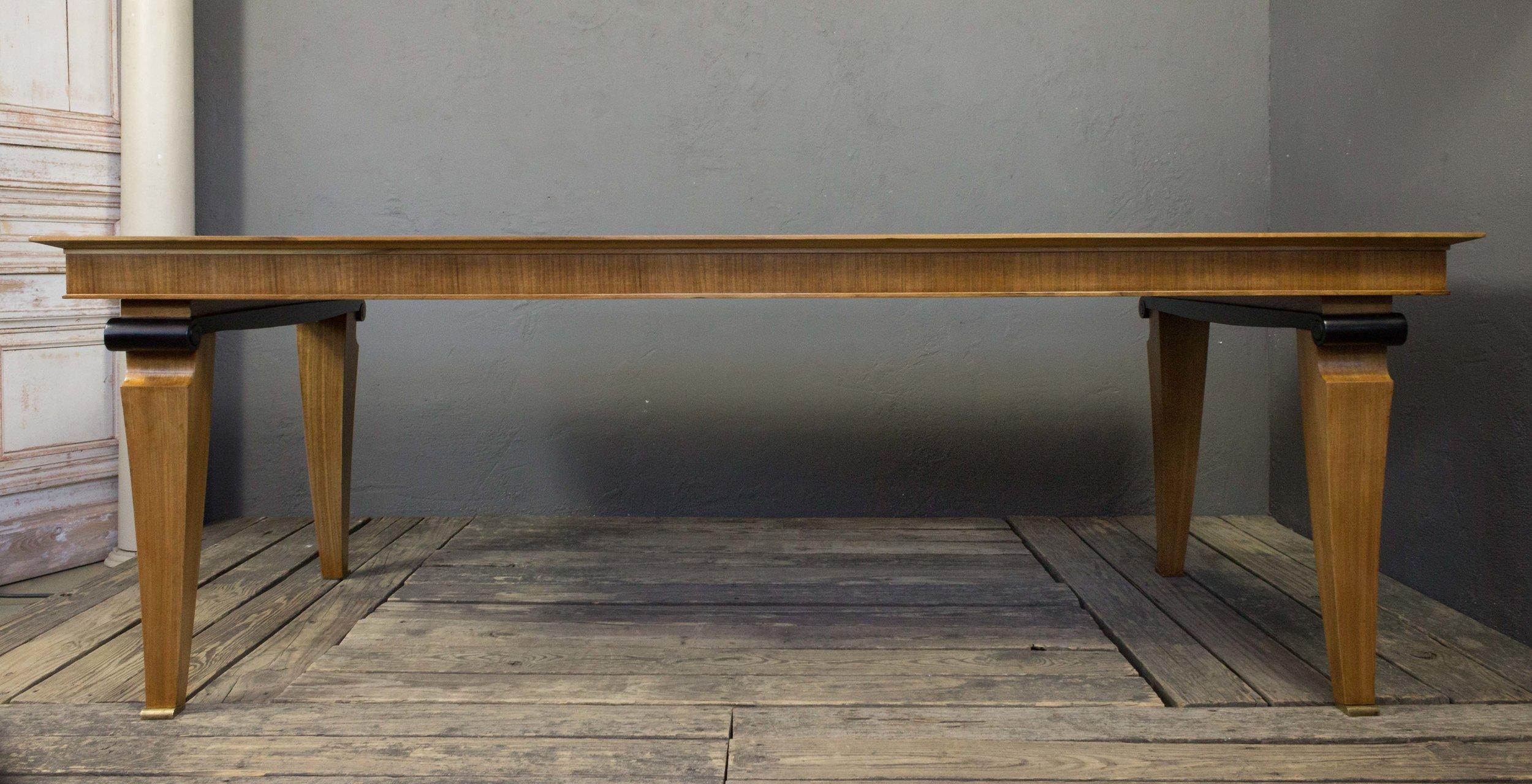 Cette table de salle à manger française en placage d'acajou est un magnifique meuble Art déco des années 1940. Le plateau en marqueterie tressée est une véritable œuvre d'art, et les touches ébonisées ajoutent une touche d'élégance à l'ensemble du
