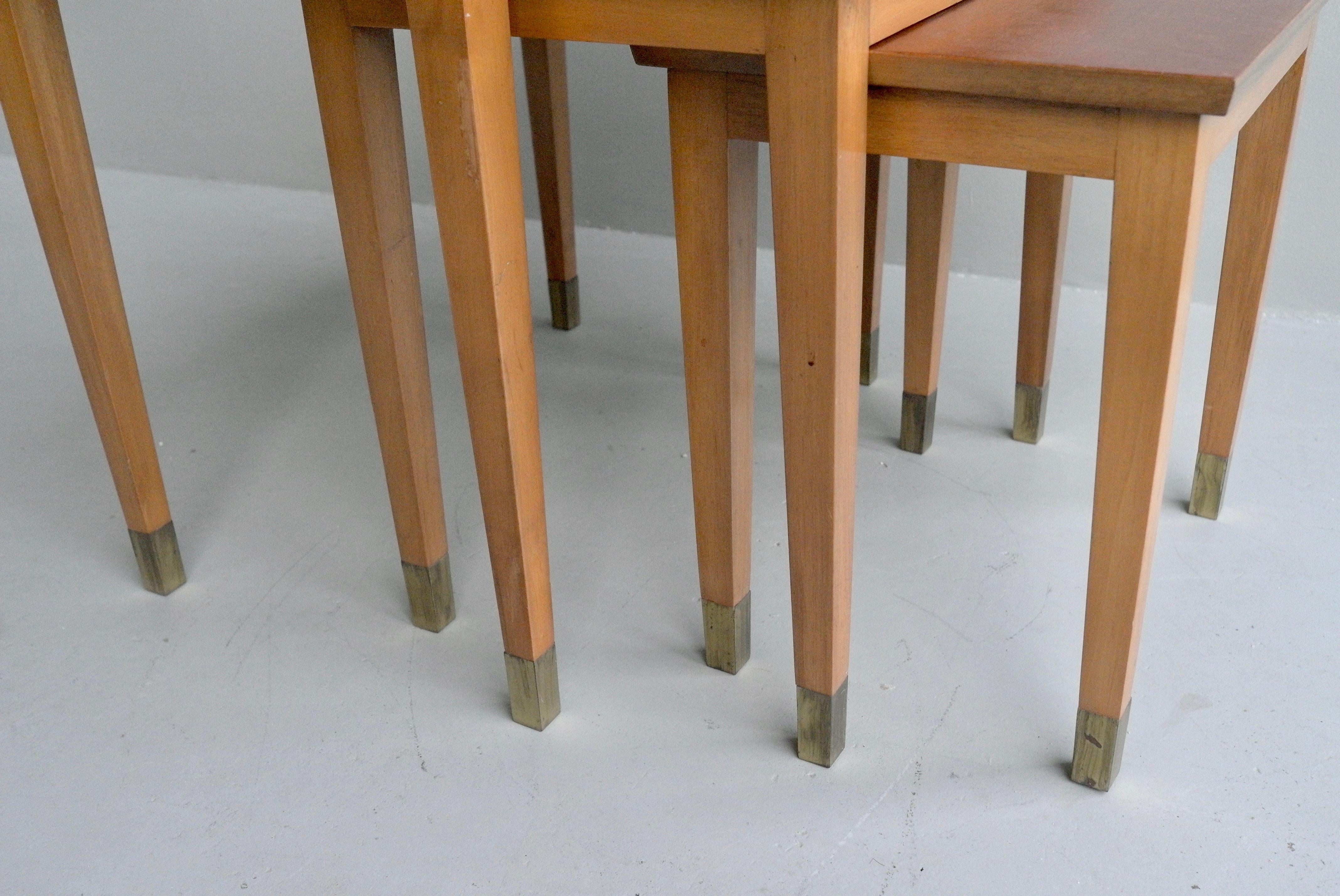 French 1940s mahogany wooden nesting tables with brass ends.