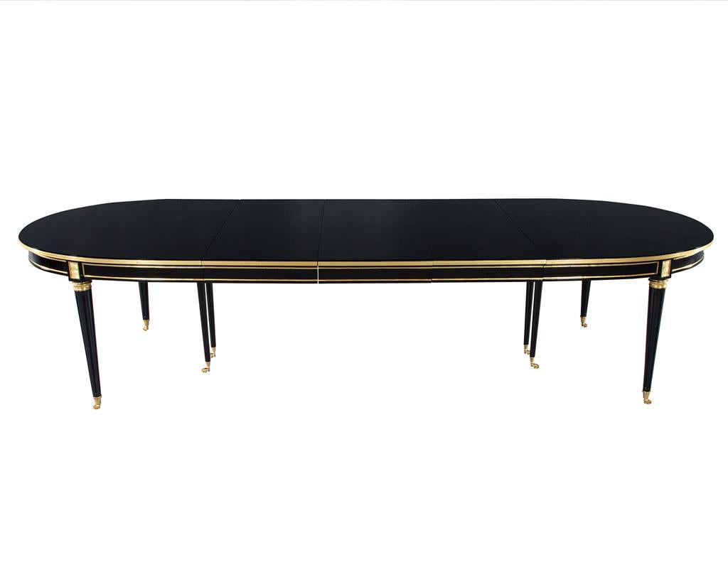 This magnificent Maison Jansen Dining Table, restored to its former glory, is sure to be the centrepiece of any dining room. The exquisite French 1940's style is evident in its Louis XVI influence, and the high gloss polished black lacquer finish