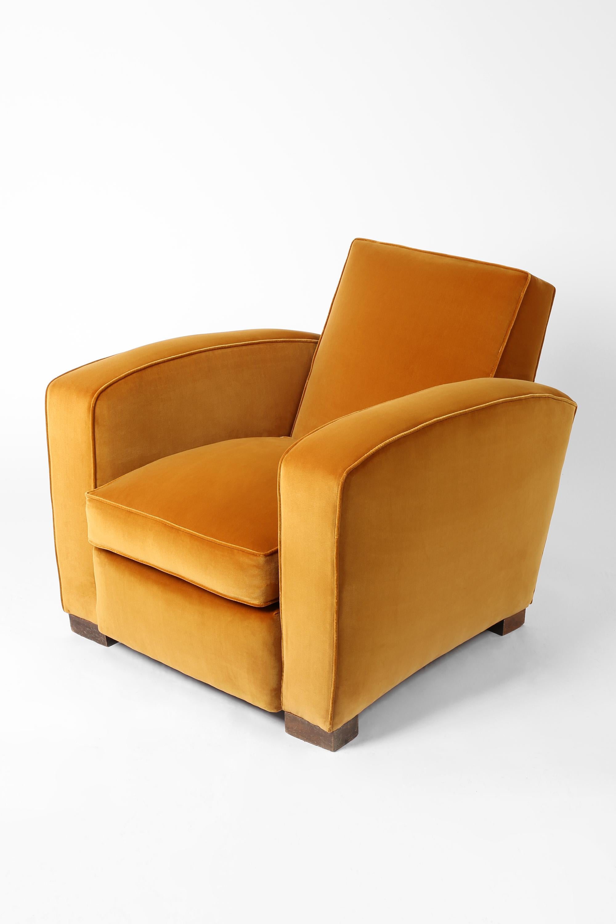 A beautifully proportioned modernist Art Deco club chair with arched, sprung armrests and simple block feet, in the manner of Jacques Adnet or Jean-Michel Frank. Restored and newly reupholstered in Rose Uniacke velvet. French, c. 1940.