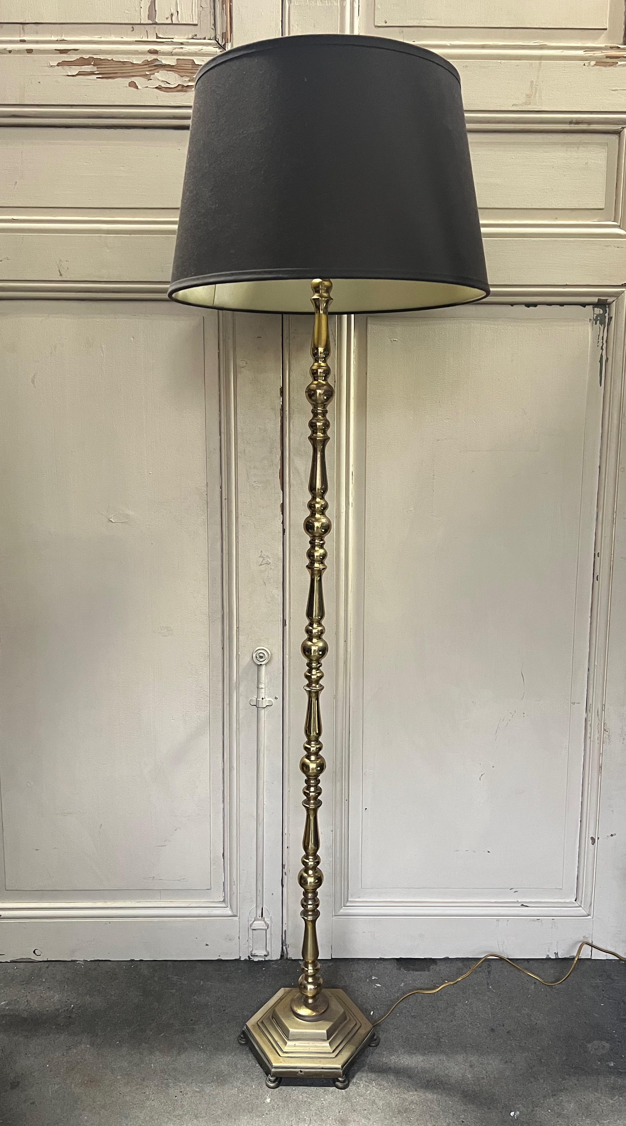 Introducing a stunning French 1940's floor lamp, expertly fashioned from high-quality brass and bronze. This captivating piece showcases a cast hexagonal base and meticulously turned components. The entire lamp has been meticulously hand-polished,