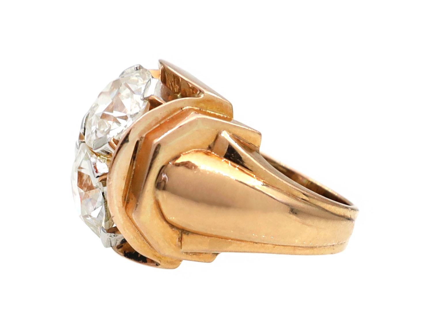 French 1940s two stone tank ring in 18kt yellow gold. Set to top with an estimated 1.45ct round Old European cut diamond in a platinum four claw setting, set beneath with an estimated 1.70ct round Old European cut diamond in a platinum four claw