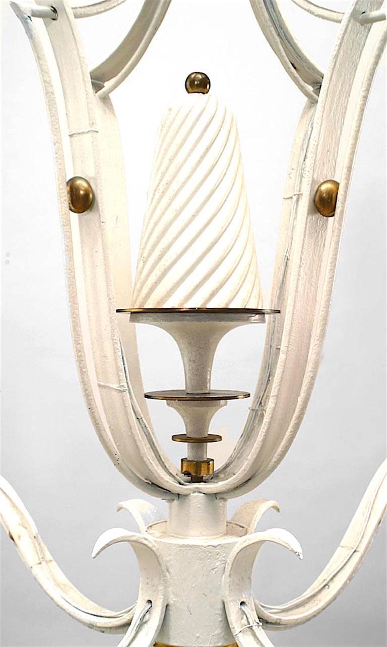 French Mid-Century (1940s) white painted and brass four light chandelier, the open lantern shaft issuing scrolling arms, scalloped drip pans & fluted tapering bobeches.
